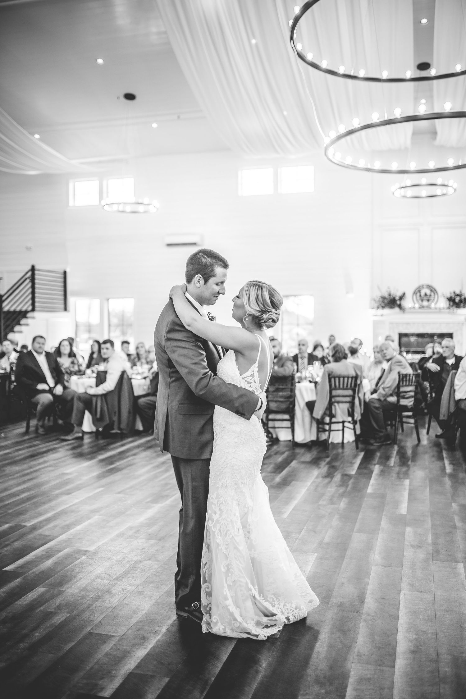 Black and white photos of a first dance sequence in an elegant ballroom setting.