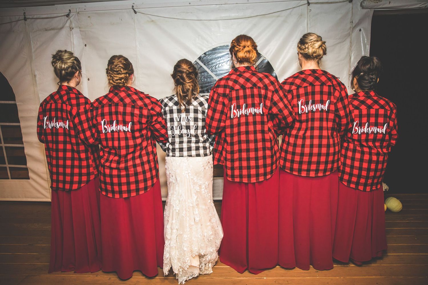 Group photo with wedding party wearing coordinated buffalo plaid and formal attire.