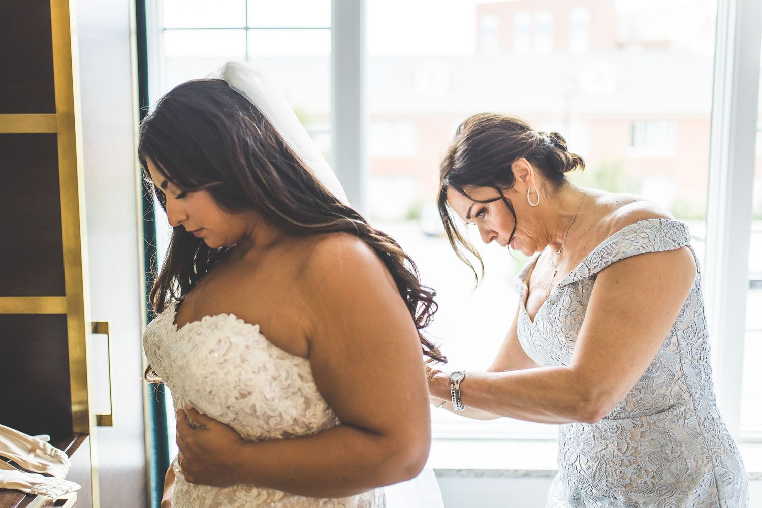 Candid moments captured during bridal preparation in a sunlit room.