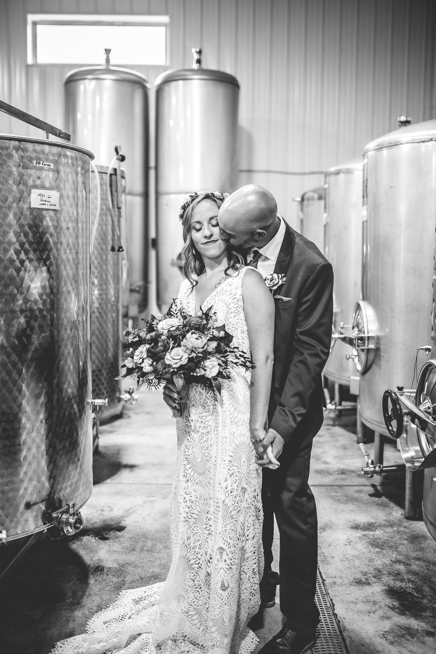 Intimate black and white wedding photos taken in a modern winery facility.