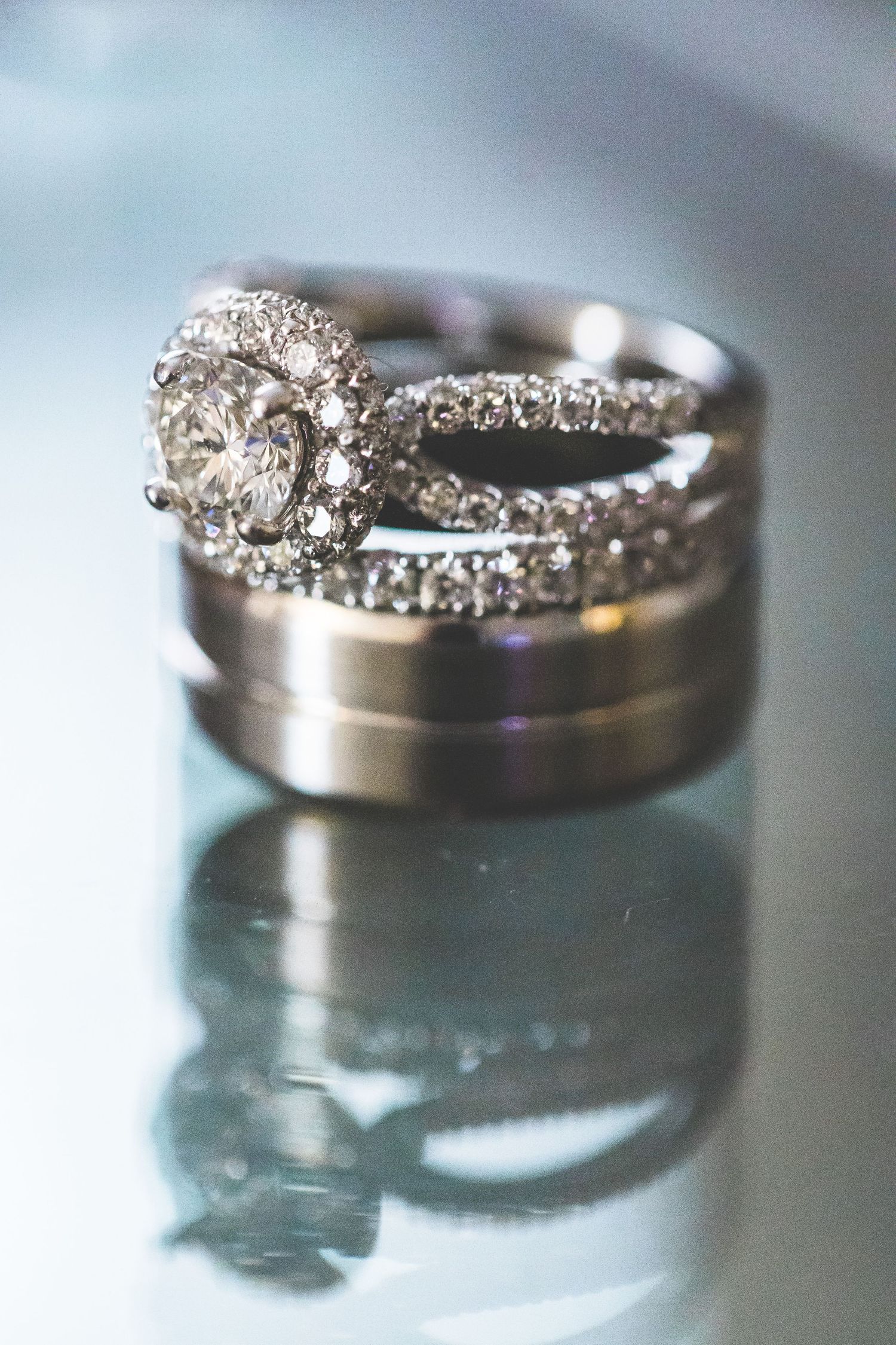 Close-up macro shots of sparkling diamond wedding rings with reflective surfaces.