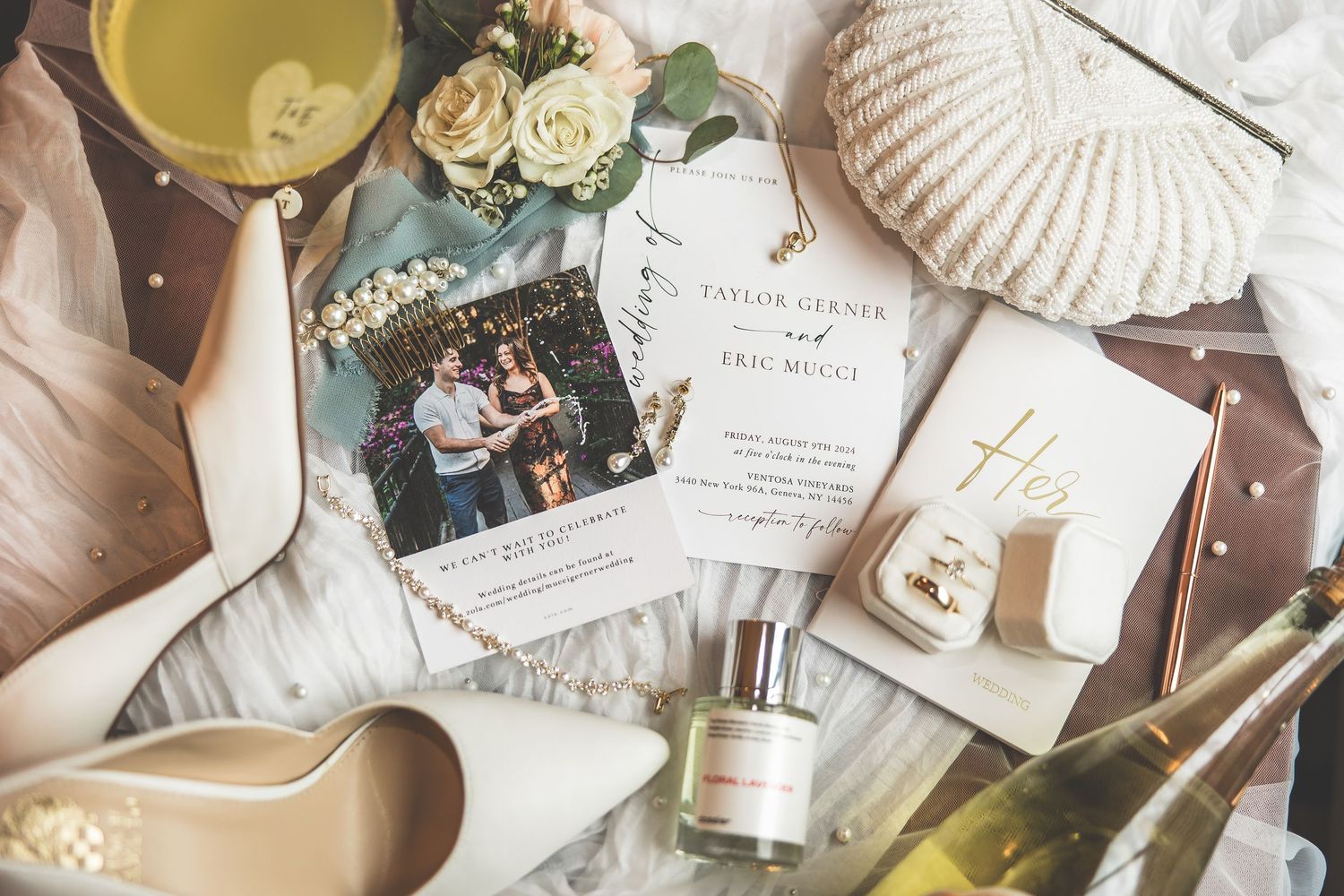 Wedding detail flatlay featuring invitations, seashells, and champagne in neutral tones.