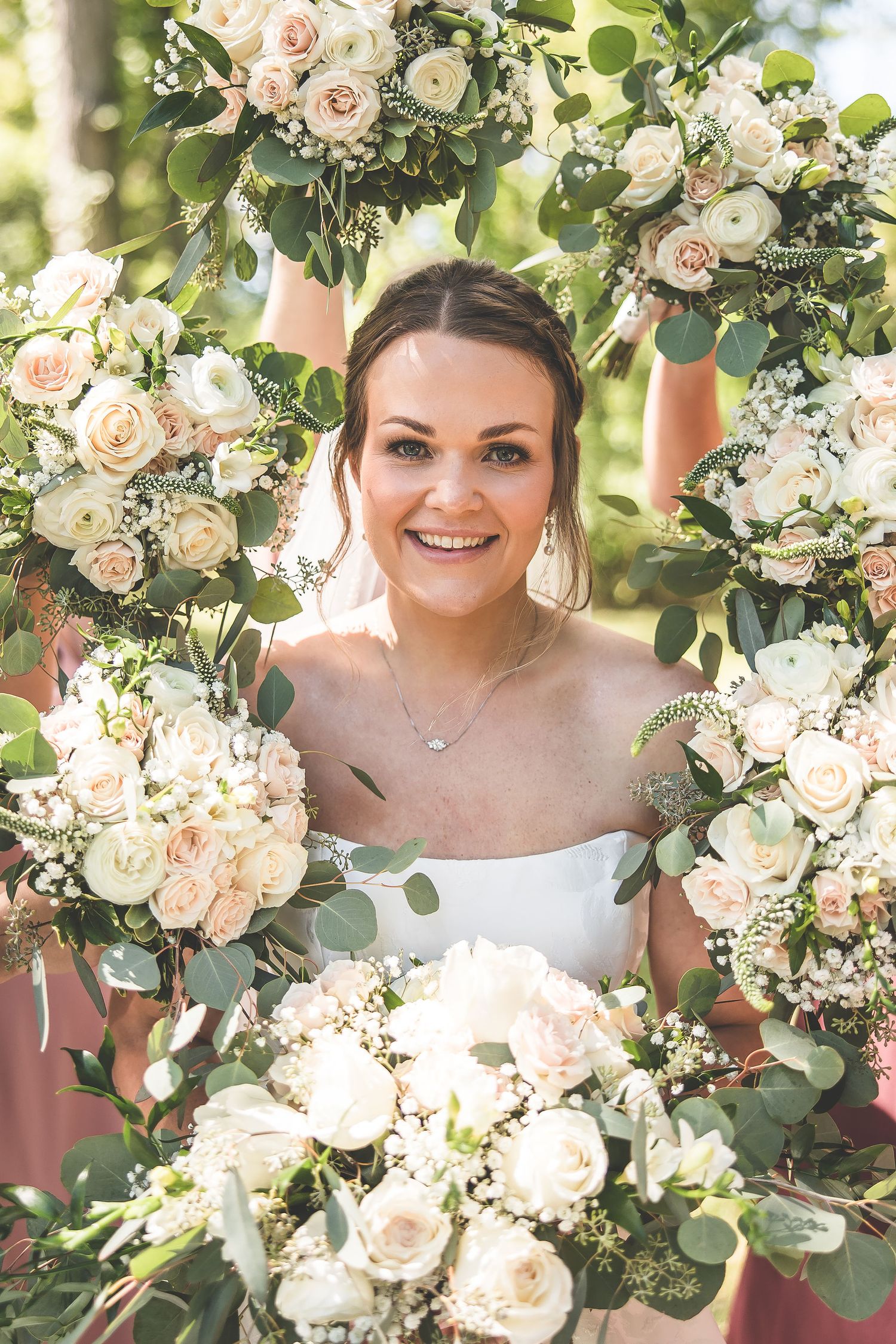 Beautiful floral wreath made of white roses and eucalyptus creates a romantic frame.