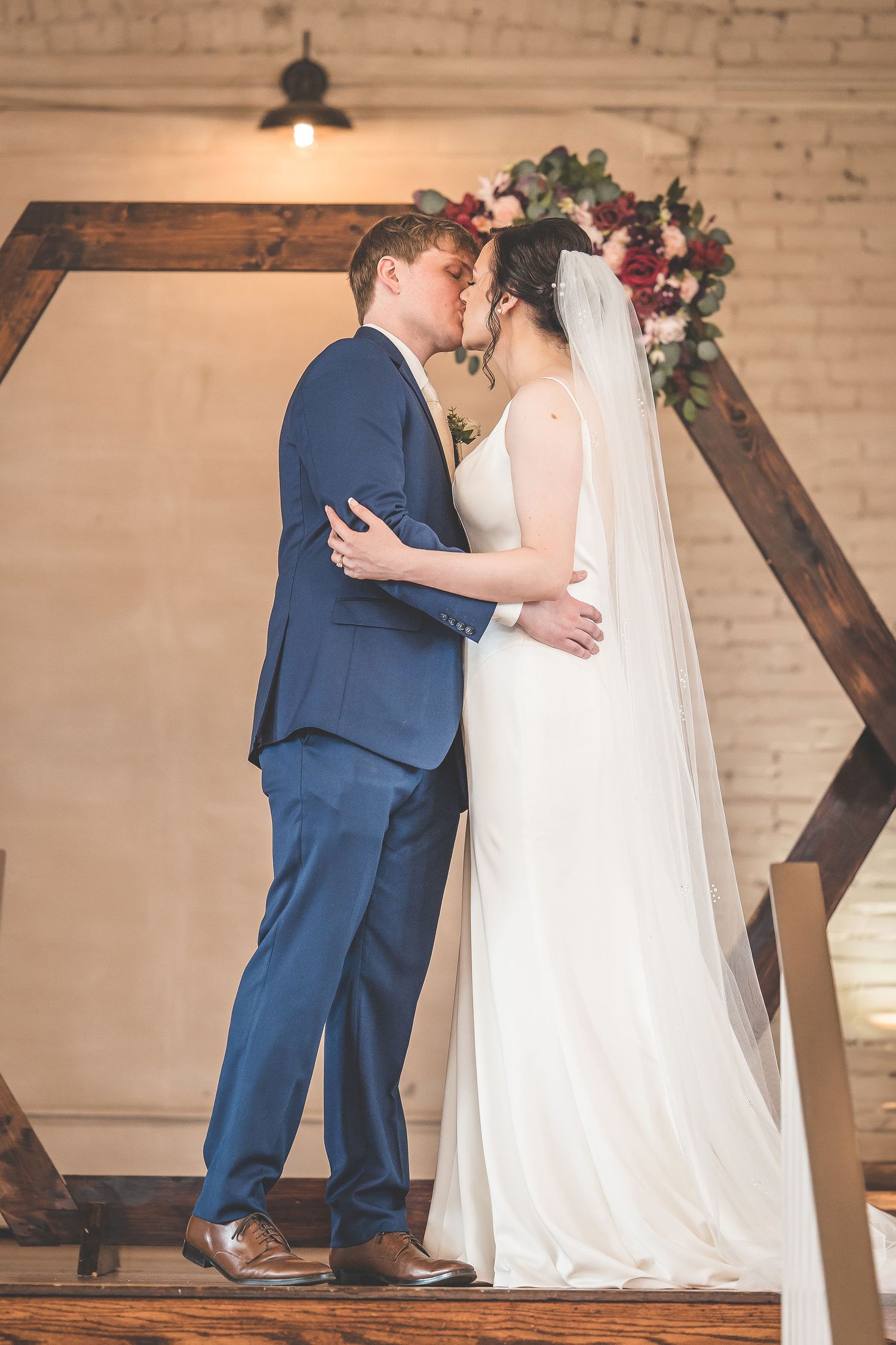 Intimate wedding ceremony moments captured in sequence against warm brick walls and wooden accents.