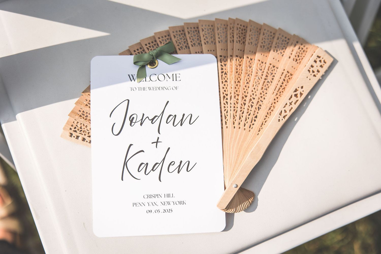 Wedding place cards with elegant calligraphy names arranged in a row.