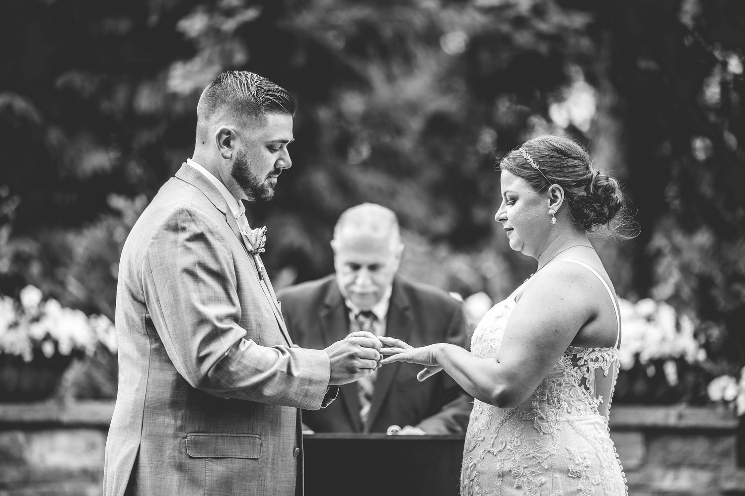 Wedding ceremony moments captured in black and white photography outdoors.