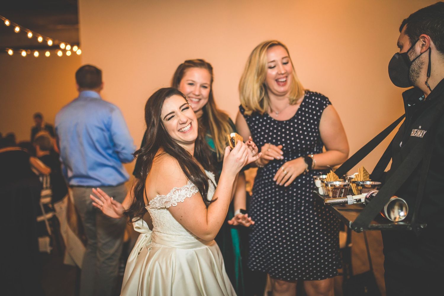 Candid moments of wedding guests dancing and celebrating during the reception party.