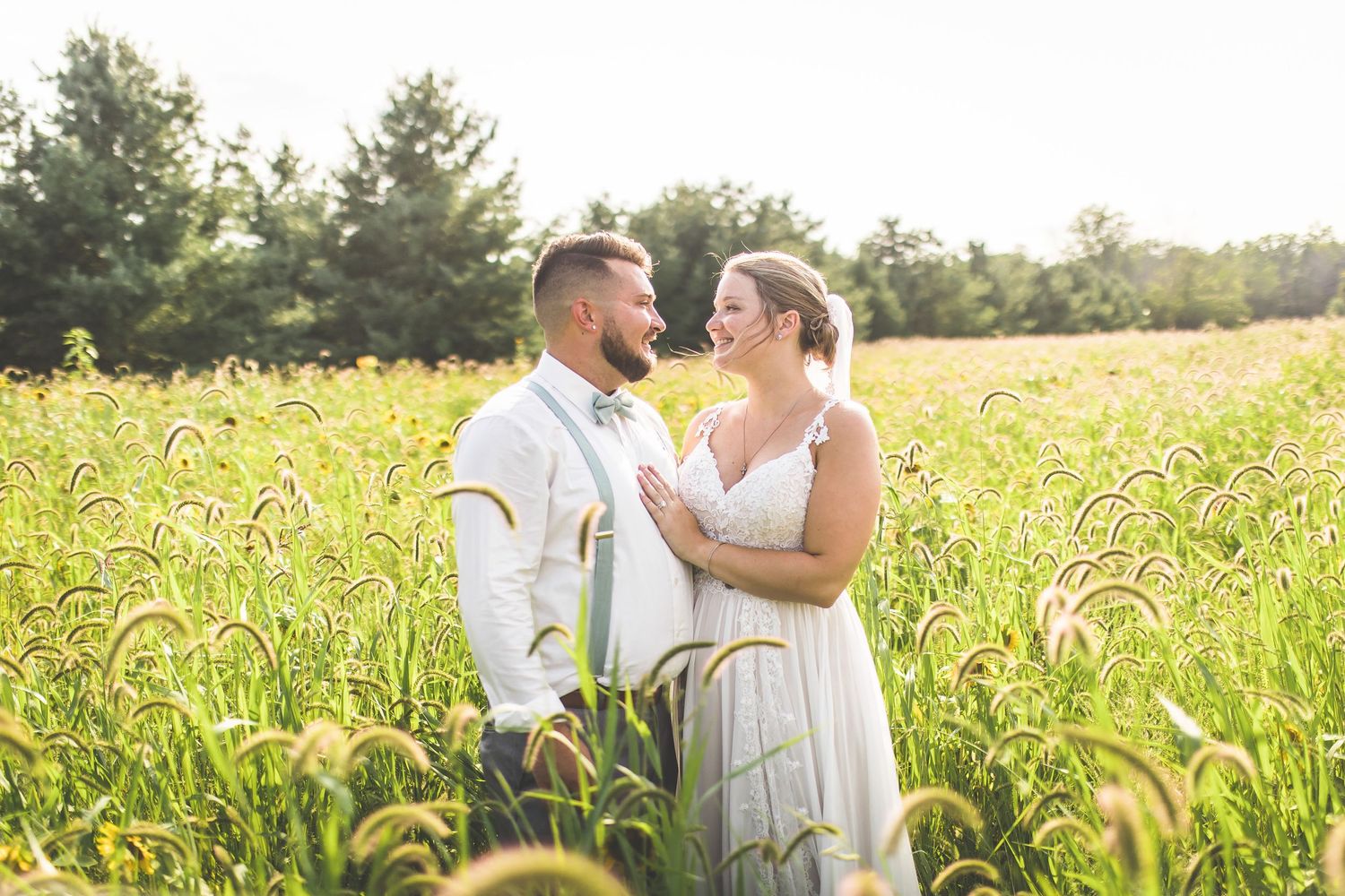 Romantic couple portraits in a golden wheat field during sunset.