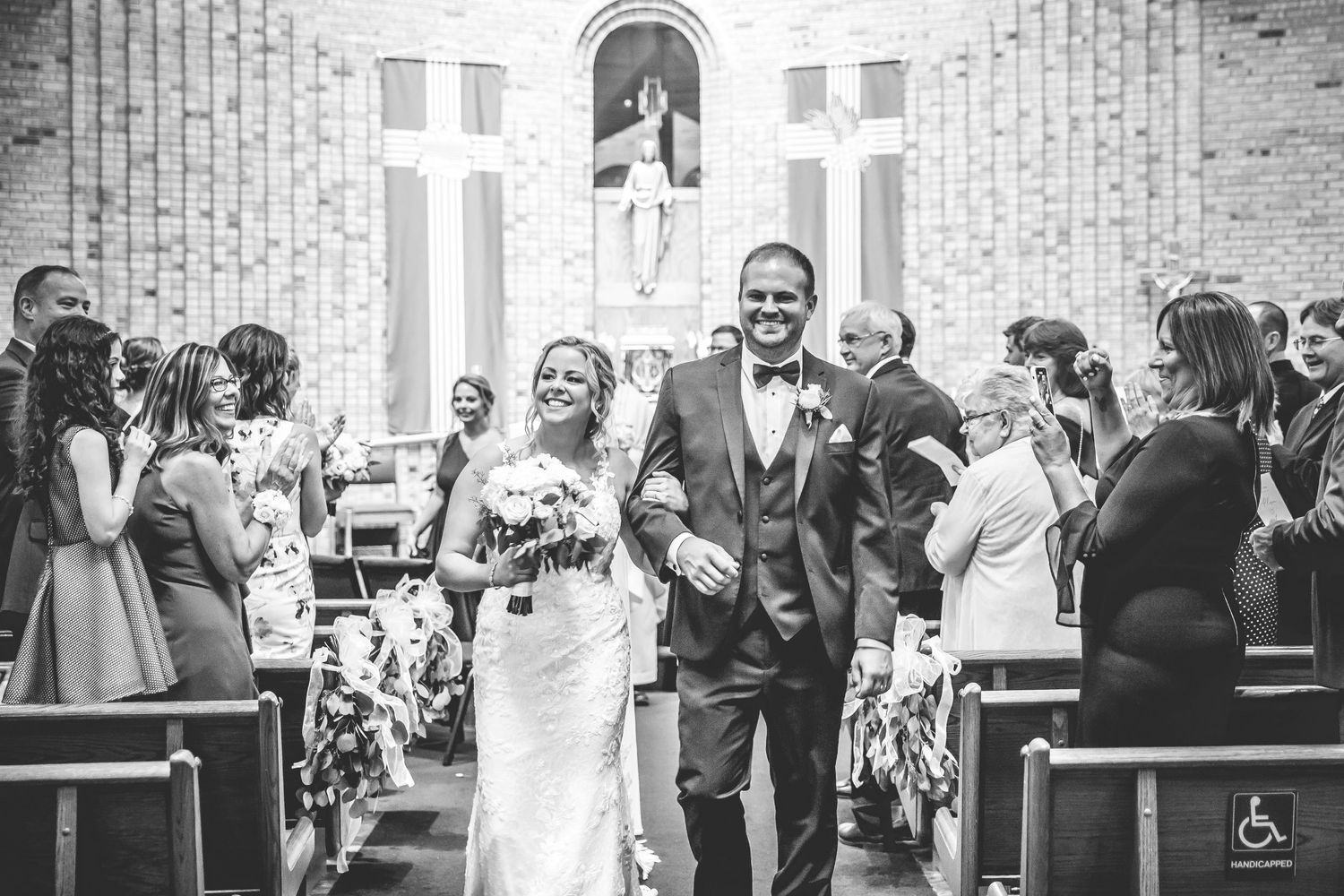 Black and white photos of wedding guests celebrating in a modern church setting.
