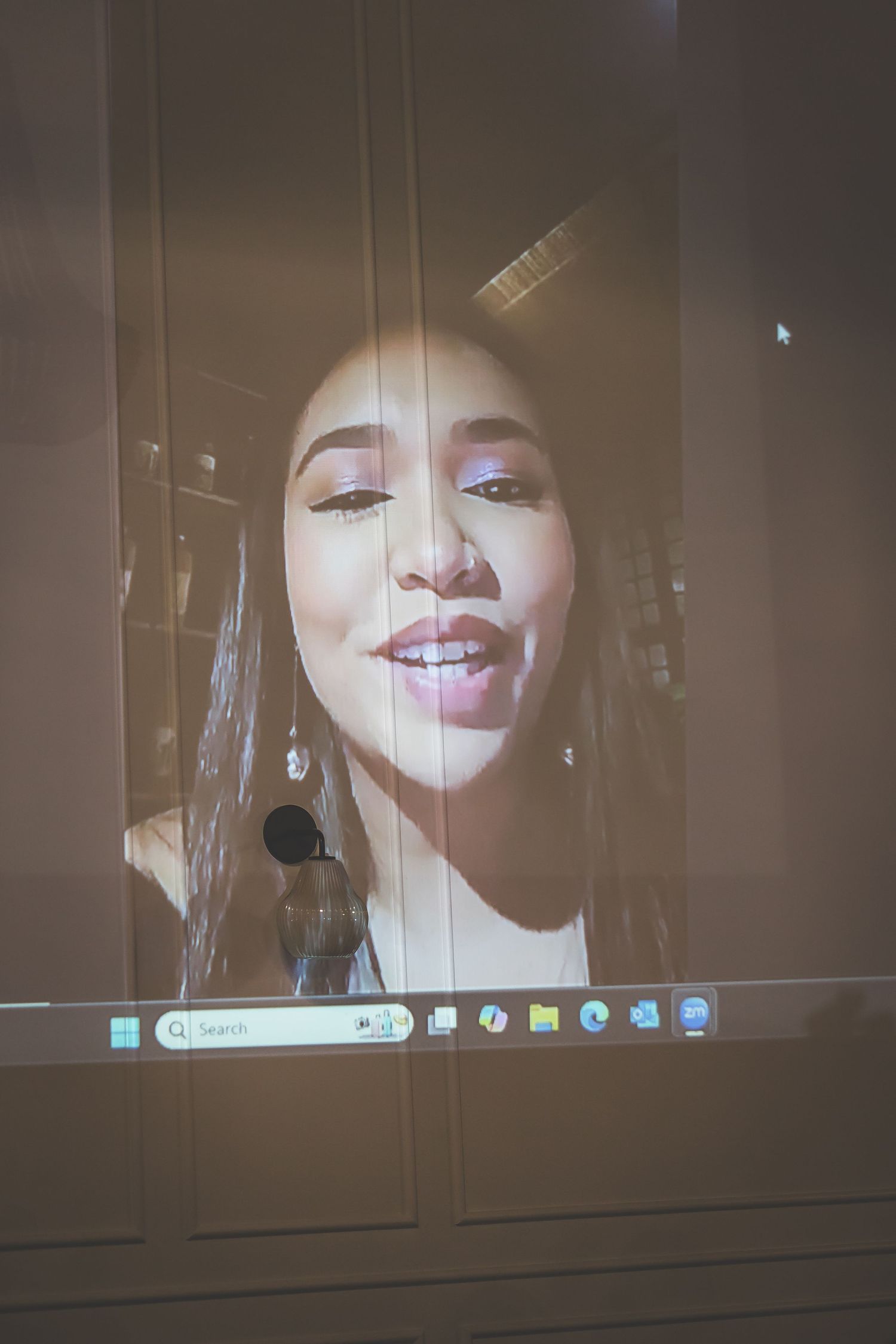 A series of video chat screenshots showing a smiling expression in a dark room.