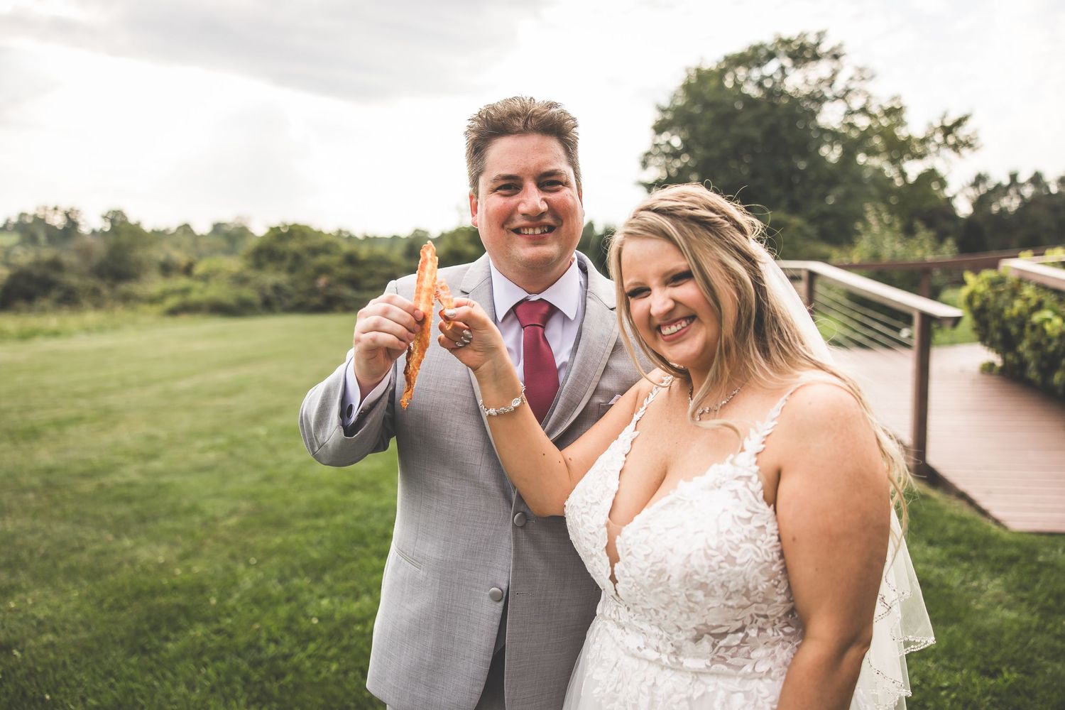 Joyful candid moments captured during an outdoor wedding photoshoot in natural surroundings.