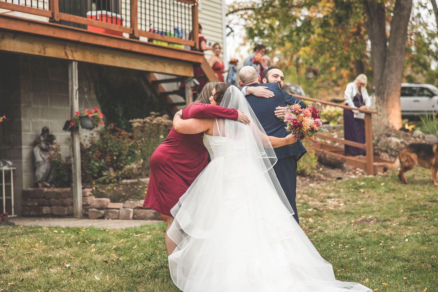 Outdoor wedding photography session featuring a couple and their loyal German Shepherd.
