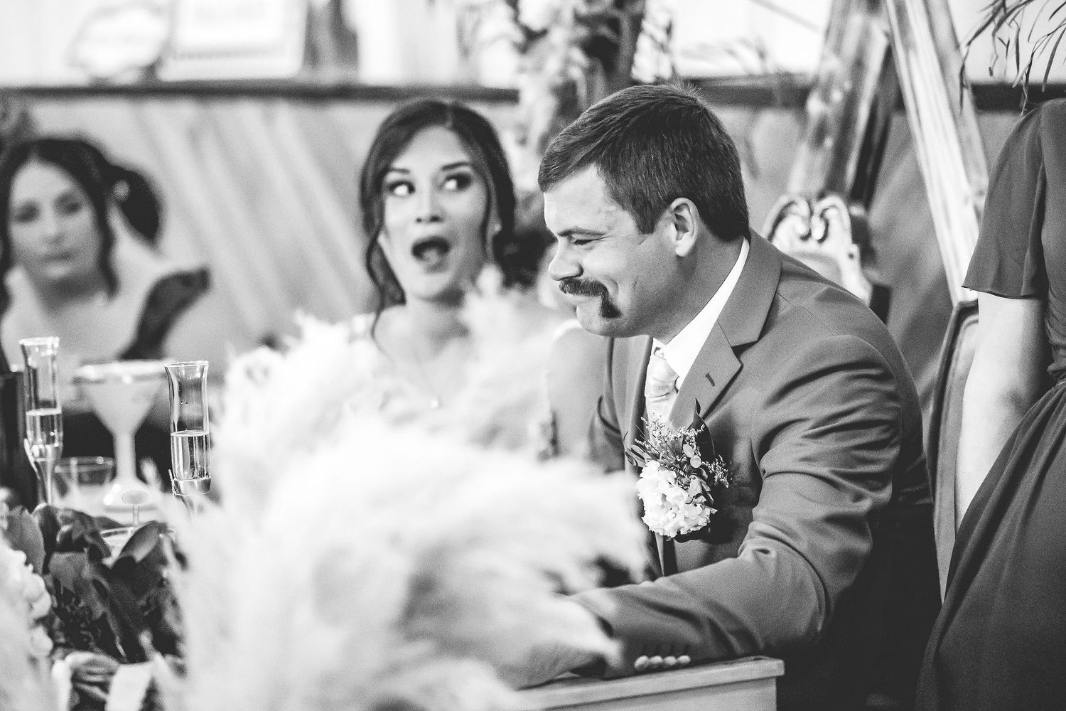 Black and white capture of wedding reception reactions and celebrations.