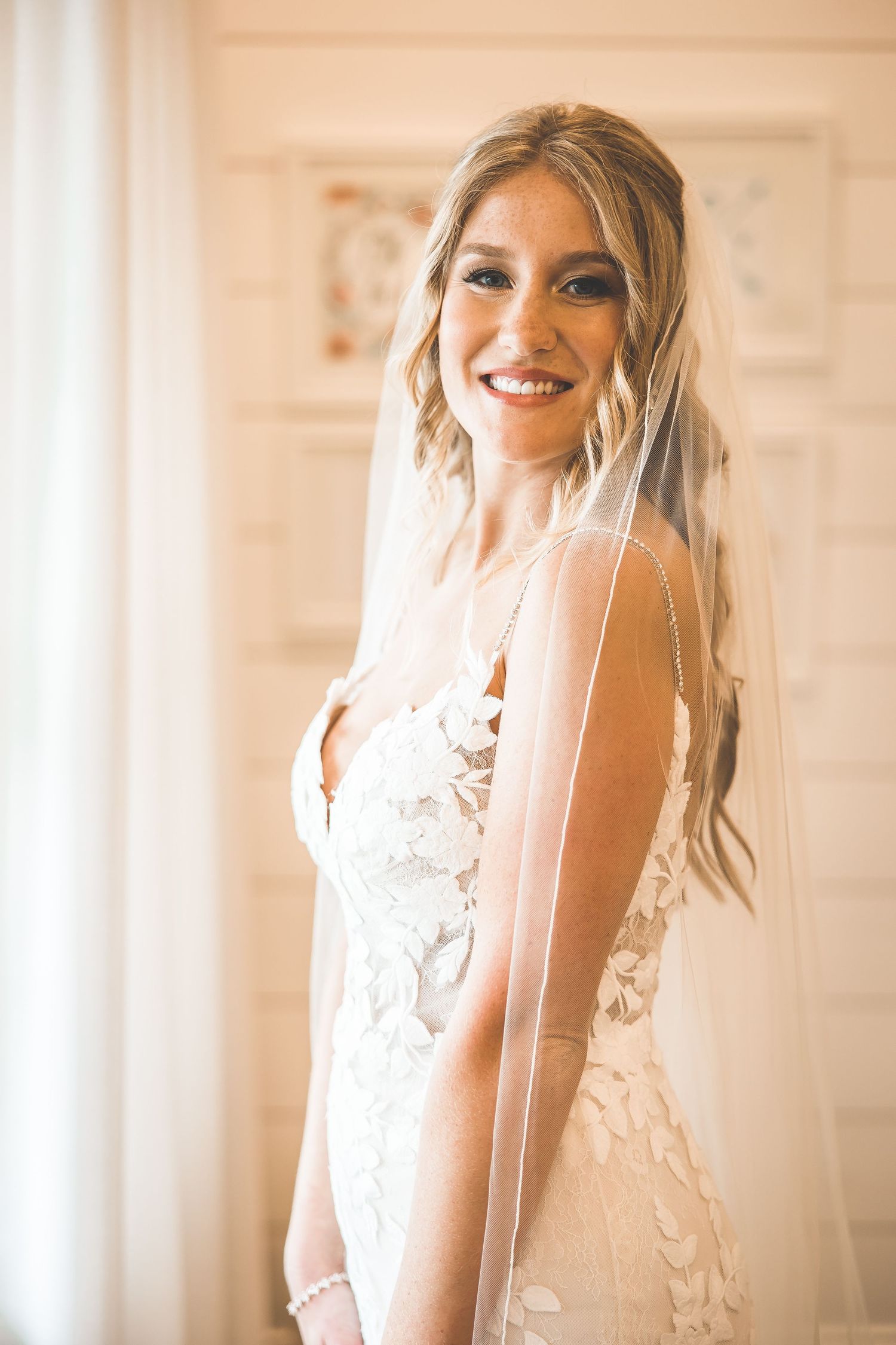 Ethereal bridal portraits showcasing a delicate veil and romantic wedding dress details.