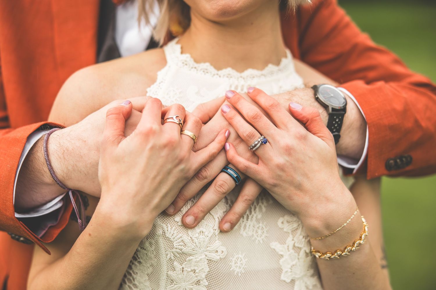 Detail shots showing hands and jewelry against a white sequined dress fabric.
