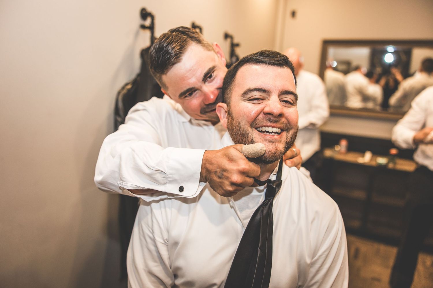 Candid moments of laughter and camaraderie among the wedding party.