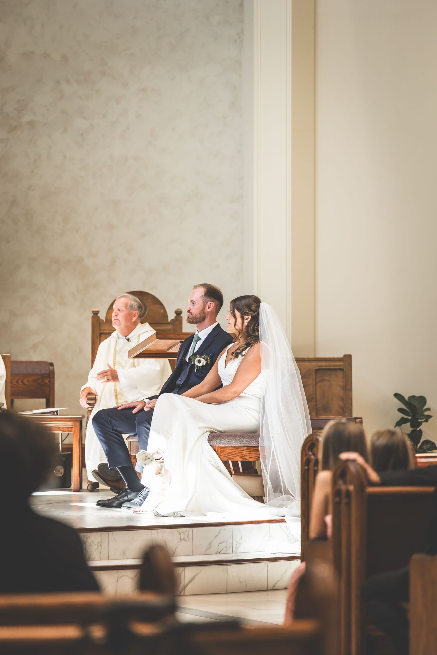 Candid moments captured during a wedding ceremony in a church pew.