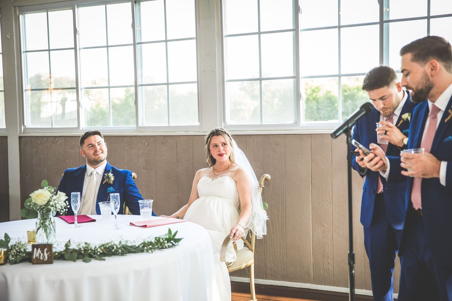 Bright and airy wedding venue with floor-to-ceiling windows and natural light streaming in.