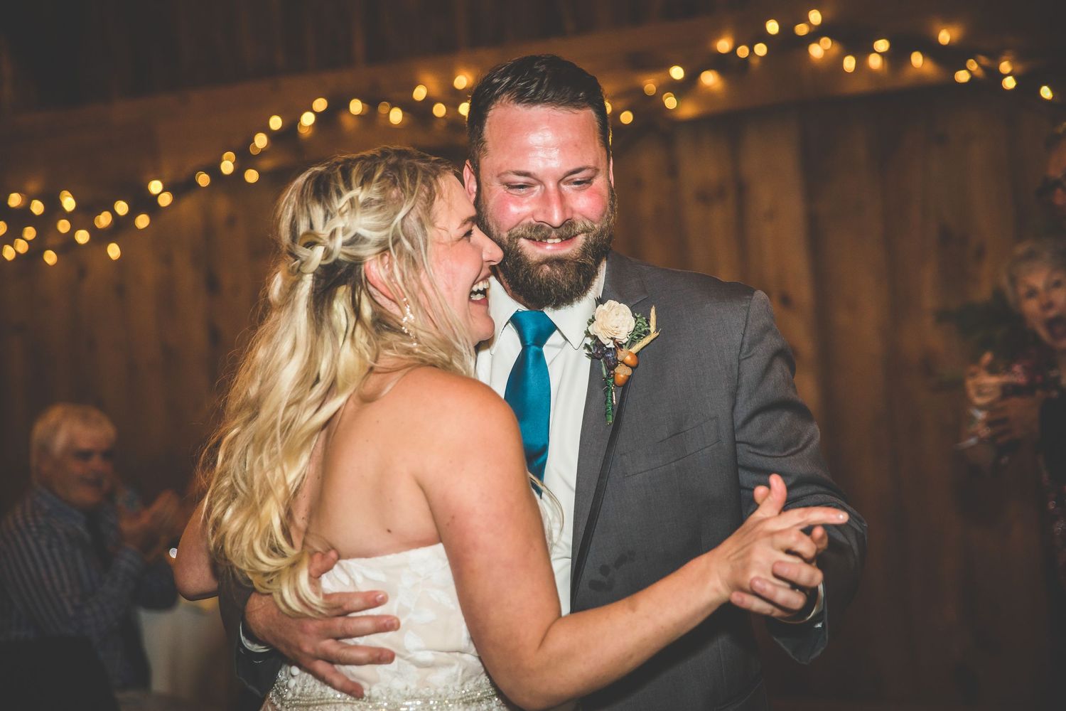 Romantic dance moment captured at dimly lit wedding reception.