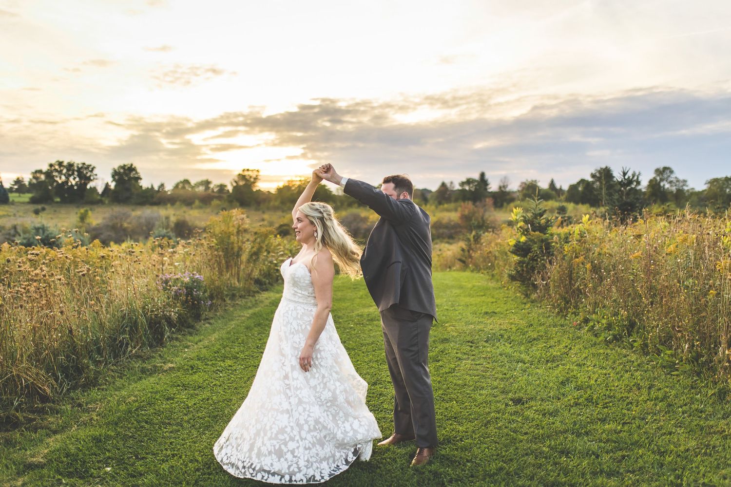 Couple takes romantic sunset photos in field of wildflowers.
