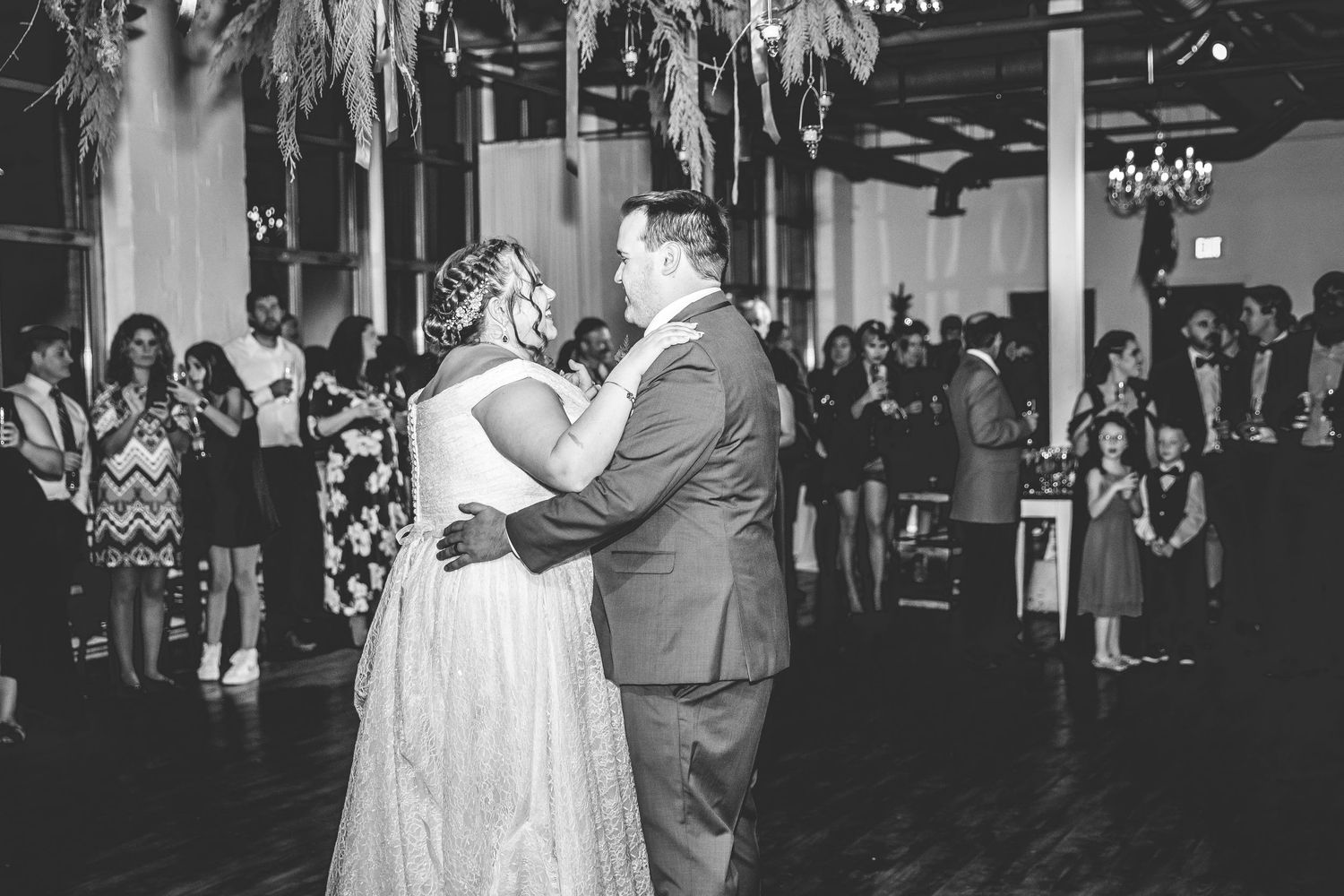 Black and white photo of couples dancing at an elegant wedding reception.