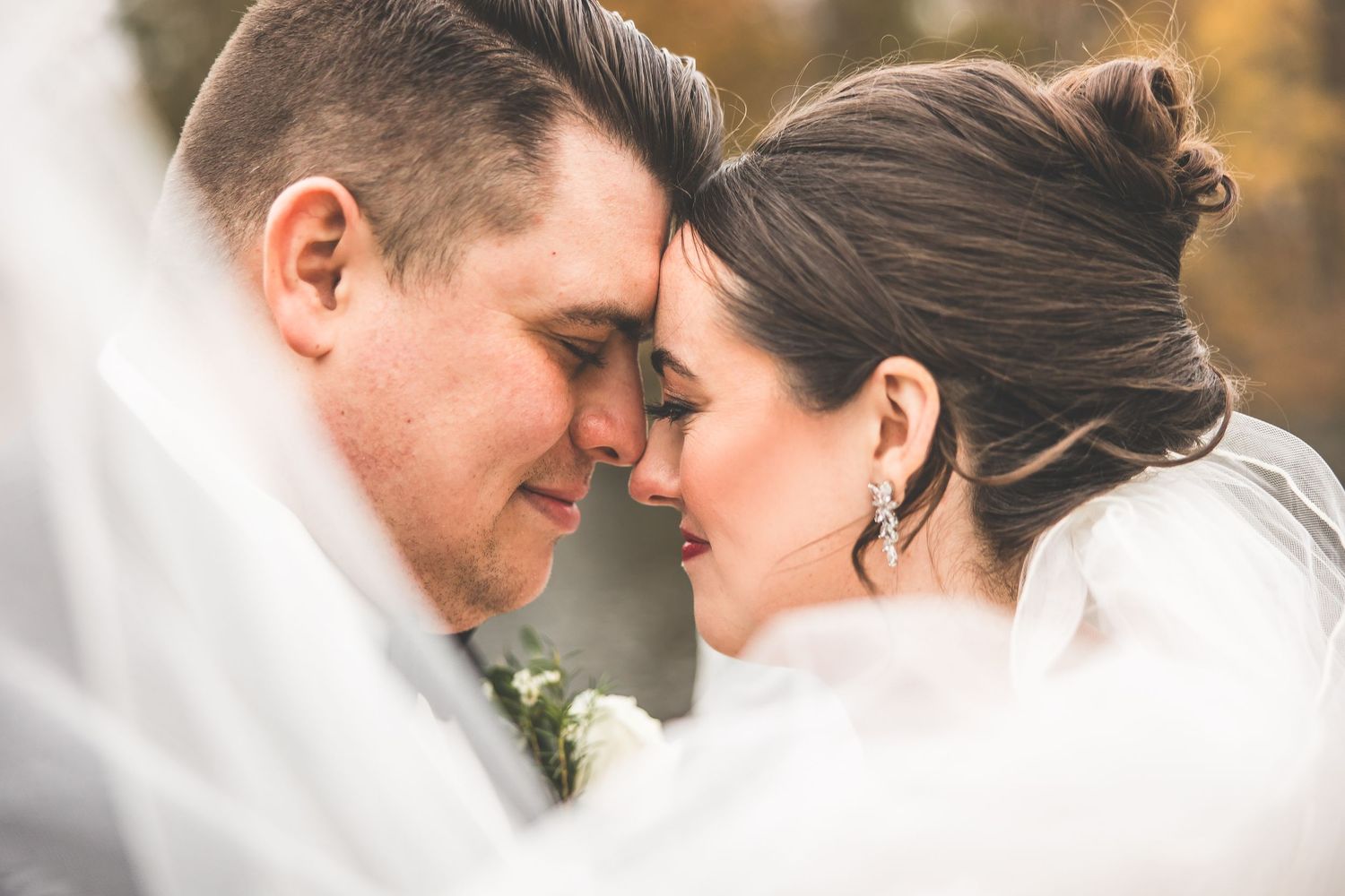 Close-up romantic moments between couple in wedding attire.