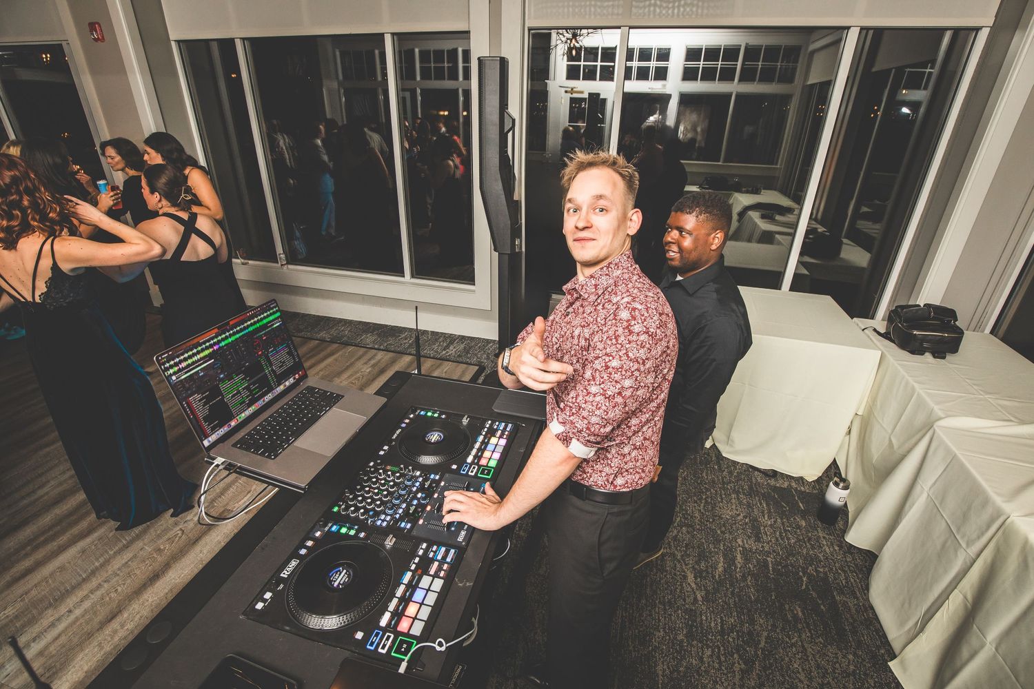Energetic dance party with guests enjoying themselves at an evening wedding reception.