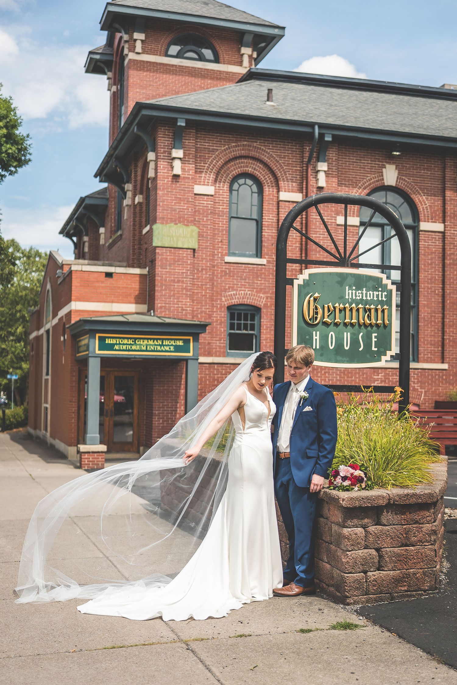 Wedding photos taken outside the historic German House building with brick architecture.