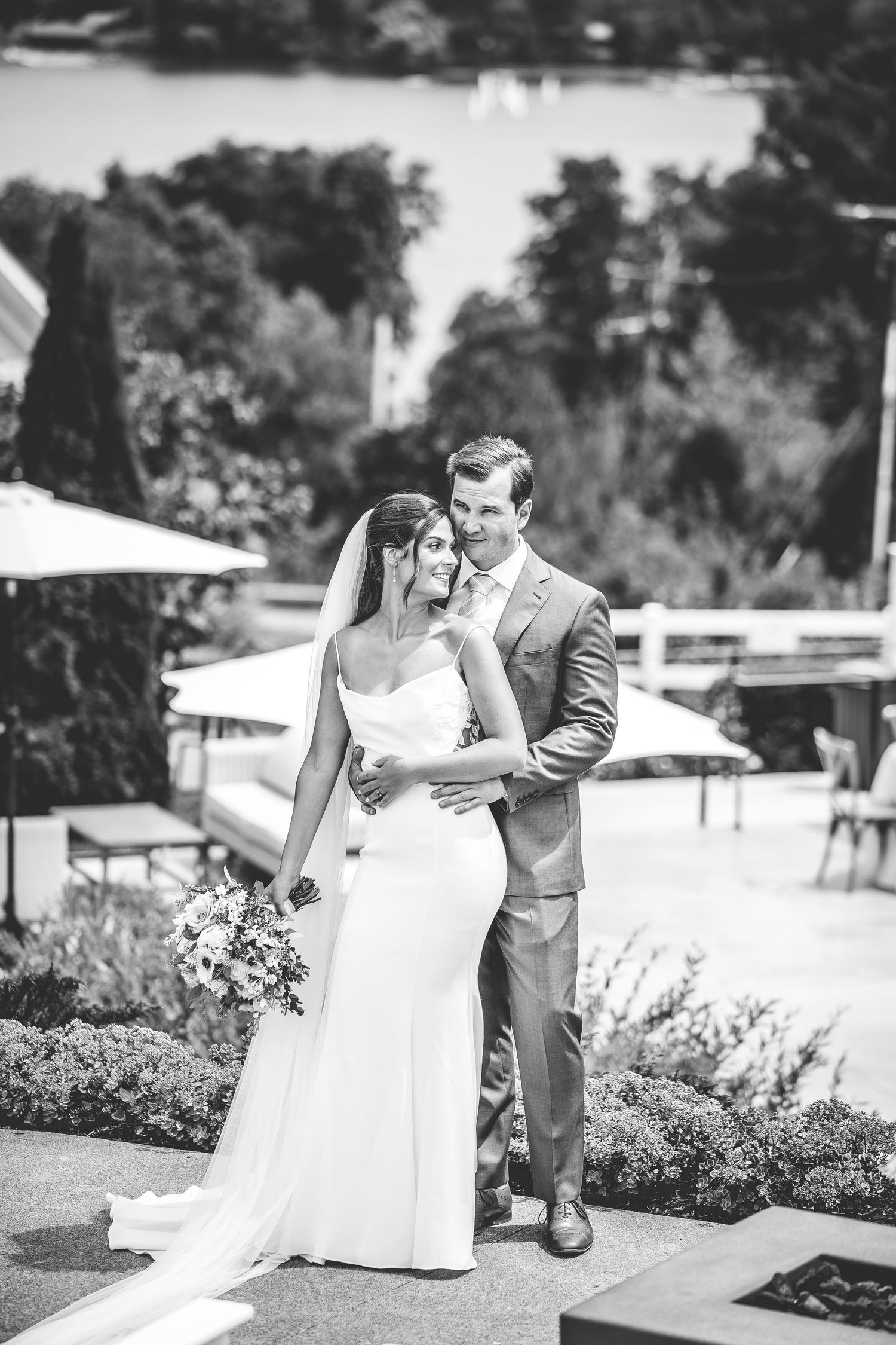 Black and white wedding portraits captured in an elegant outdoor garden setting.