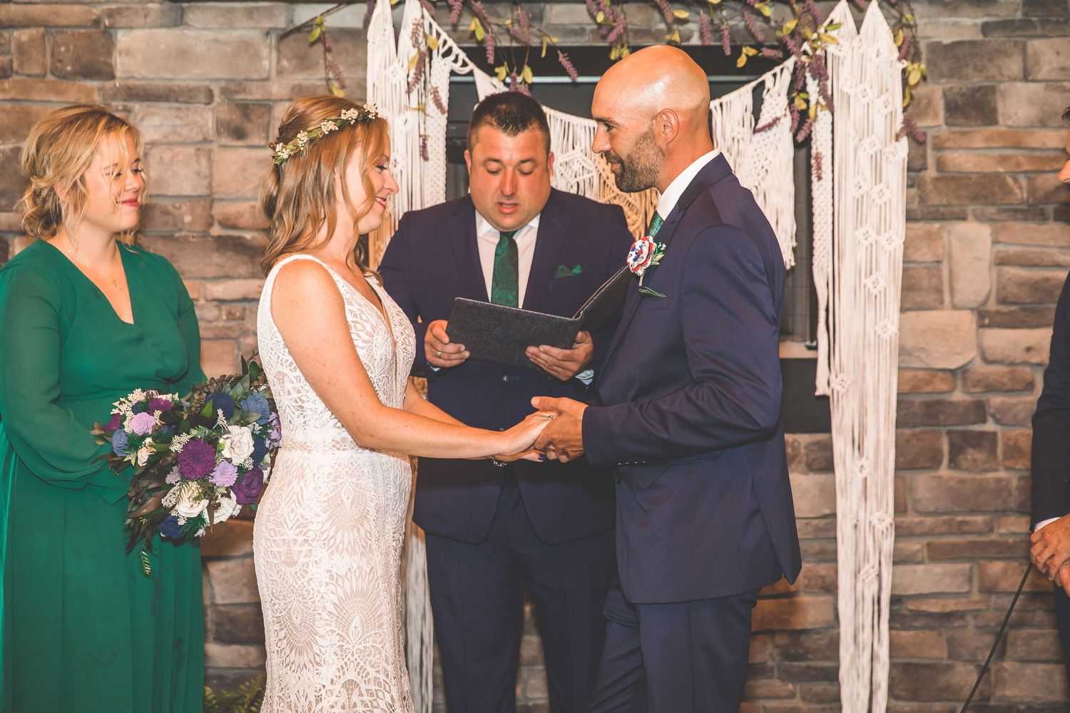 Wedding ceremony exchange with emerald green and white decor details.