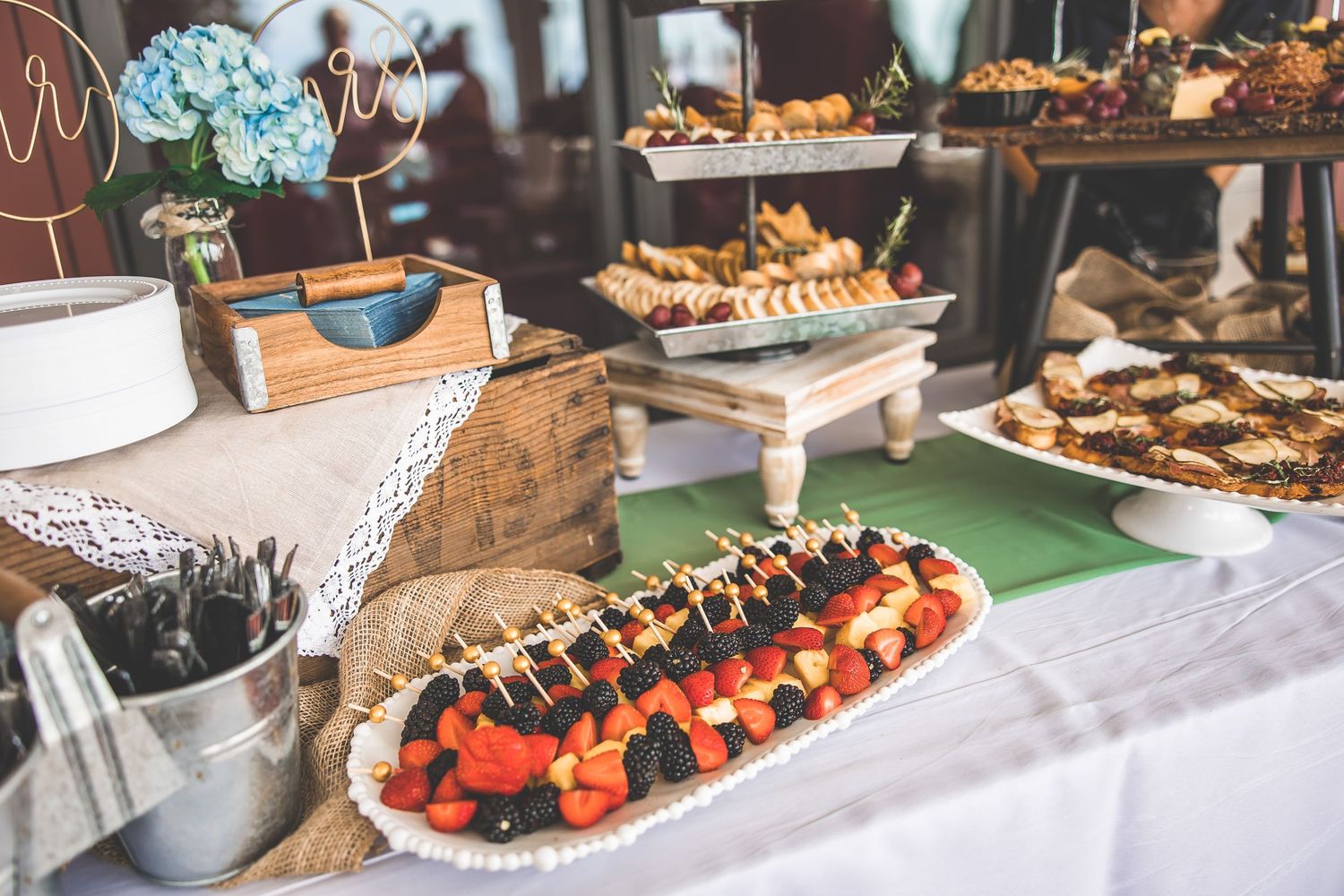Elegant wedding reception dessert table with assorted pastries and treats.