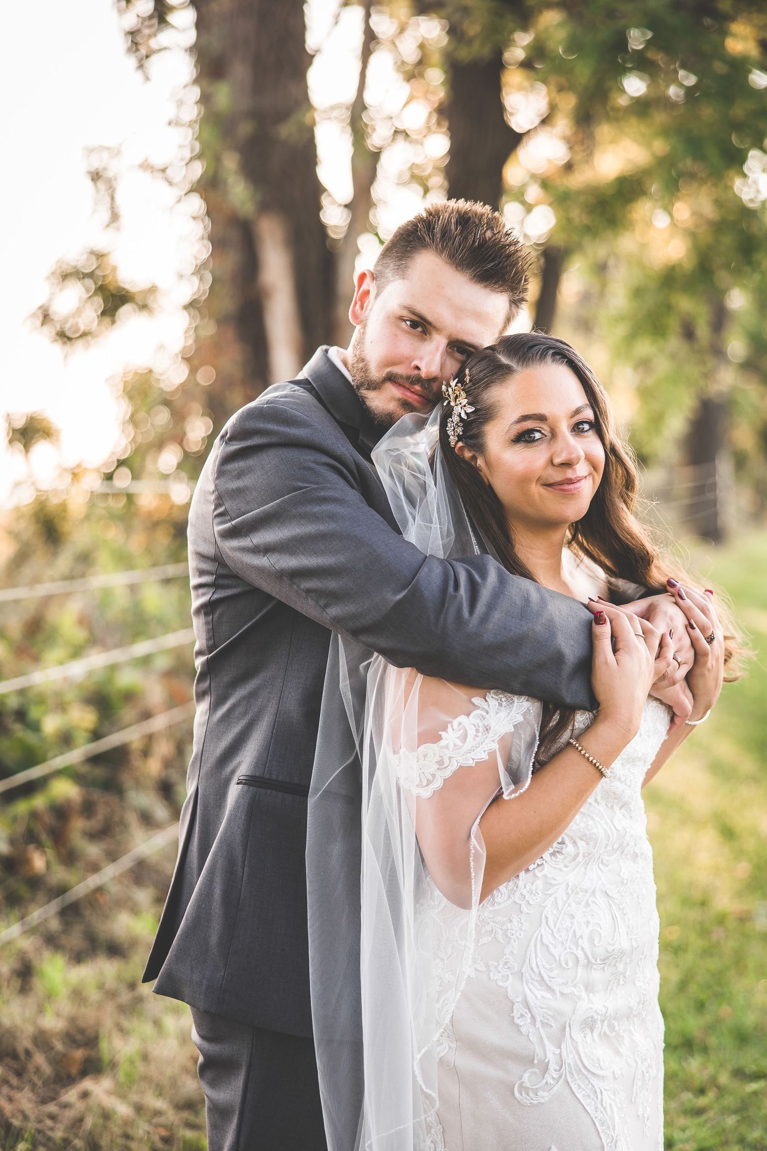 Wedding couple shares romantic moments in an outdoor setting with natural lighting.