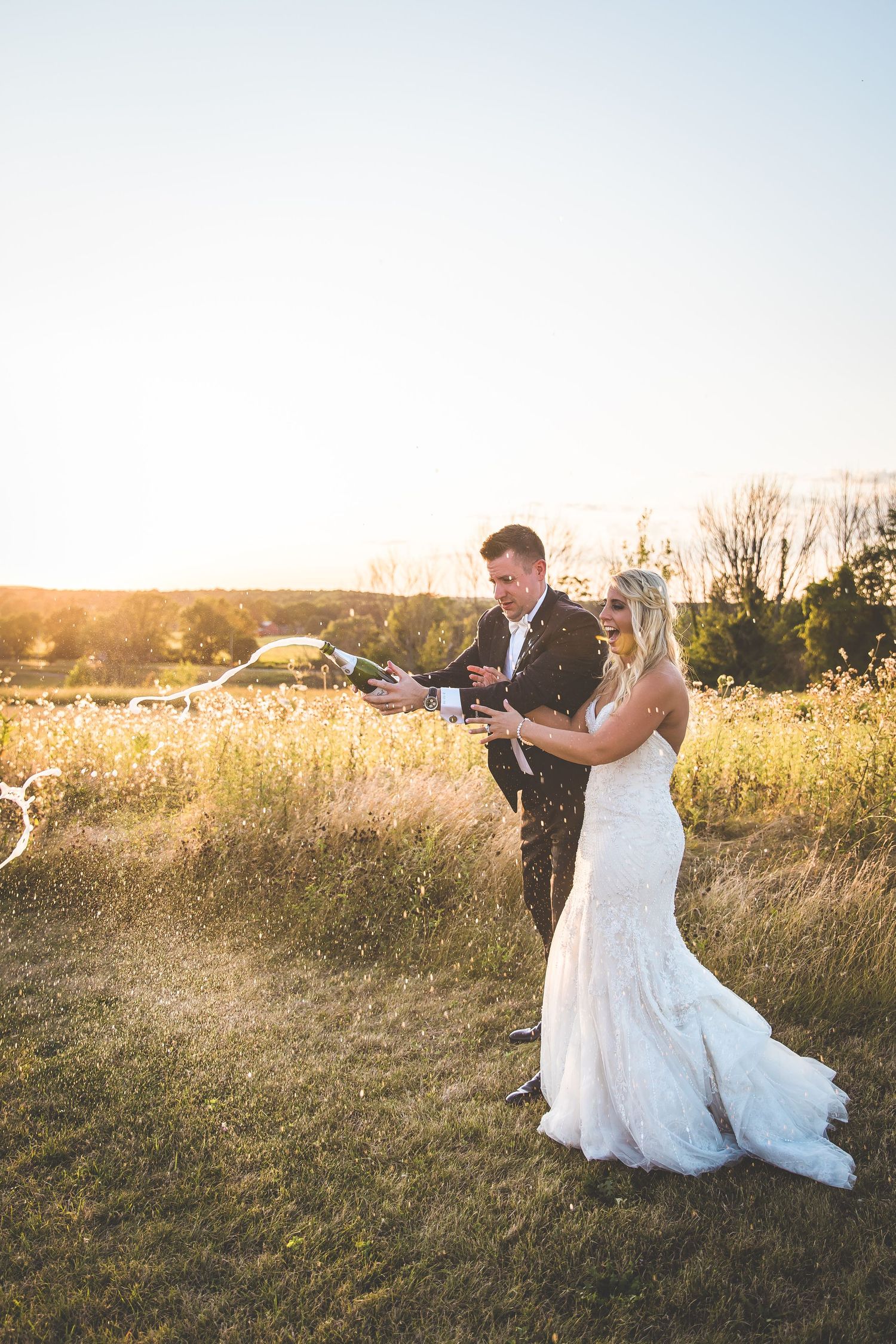 Romantic sunset portraits in a golden field with flowing white dress.
