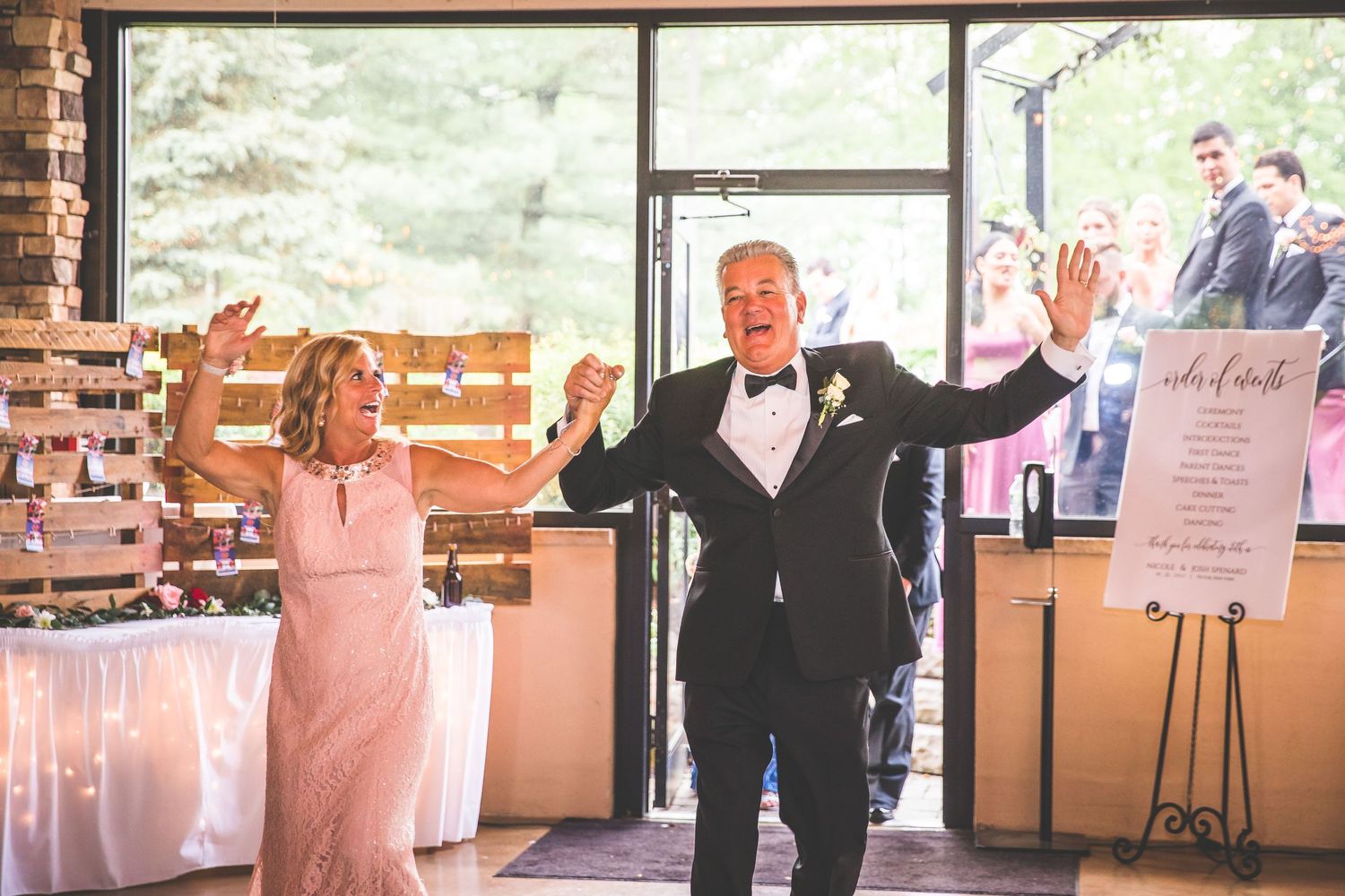 Wedding reception venue decorated with string lights and rustic wooden details.