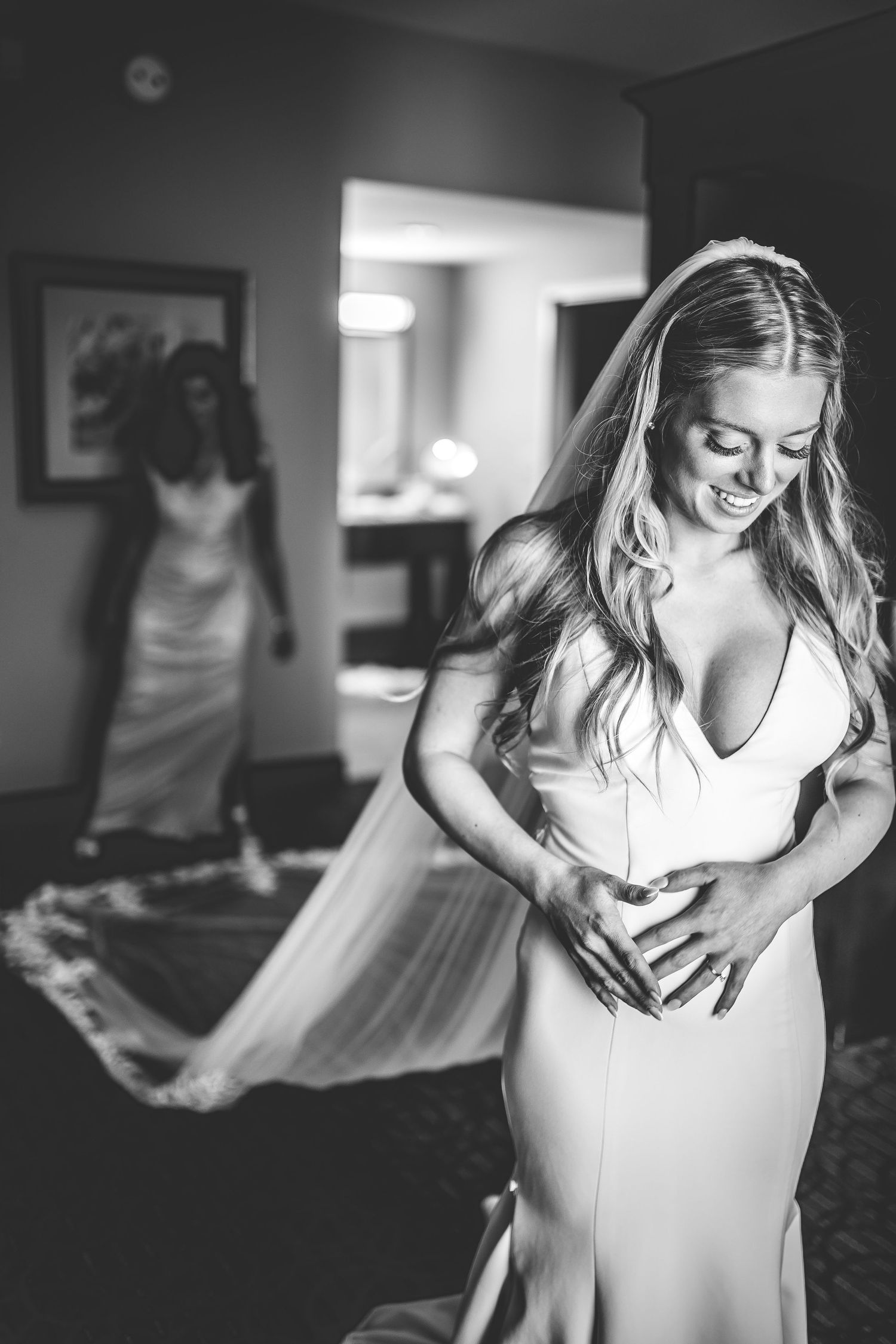 Black and white artistic shots of bride getting ready in her wedding dress.
