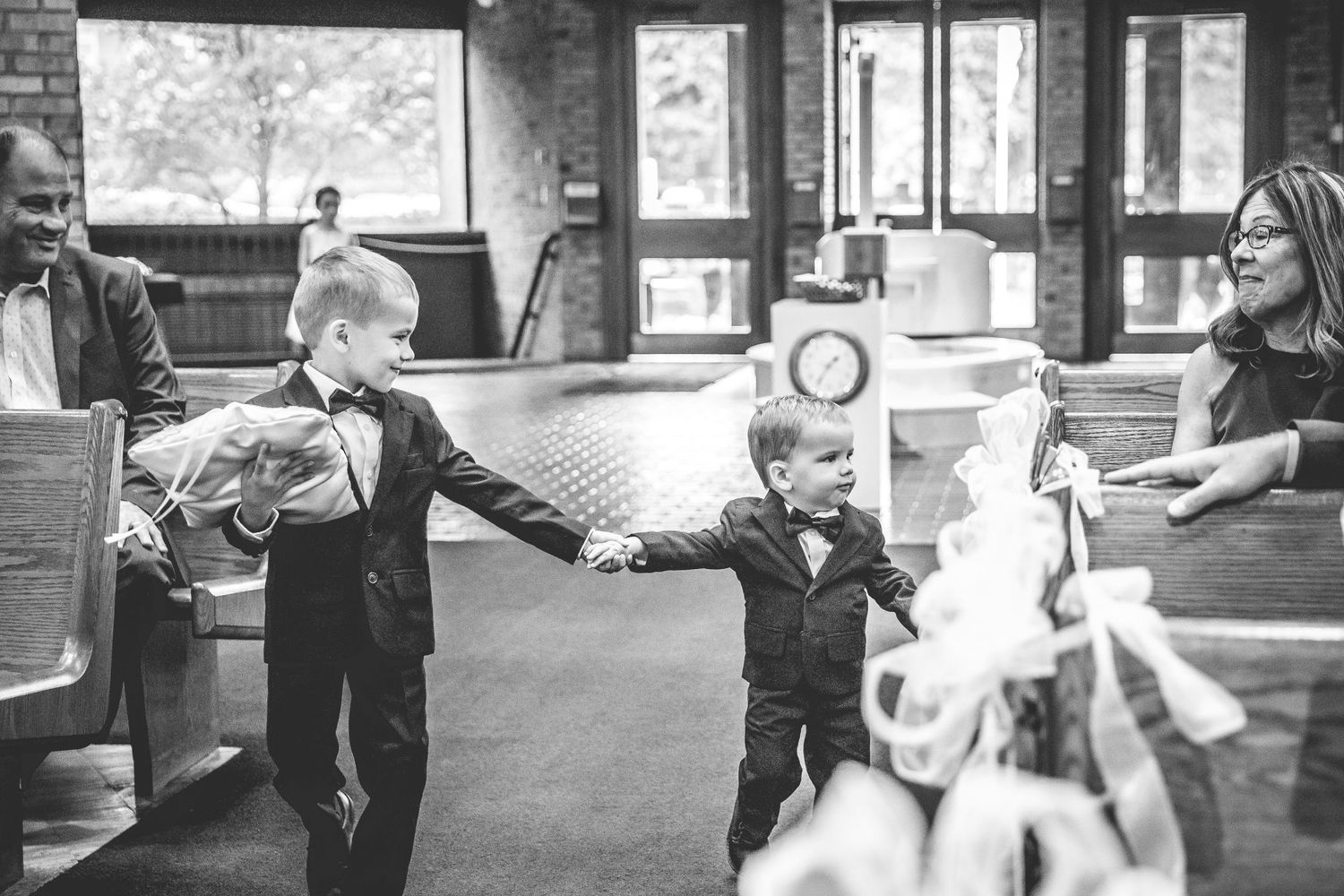 Black and white candid shots of wedding guests at a rustic venue.