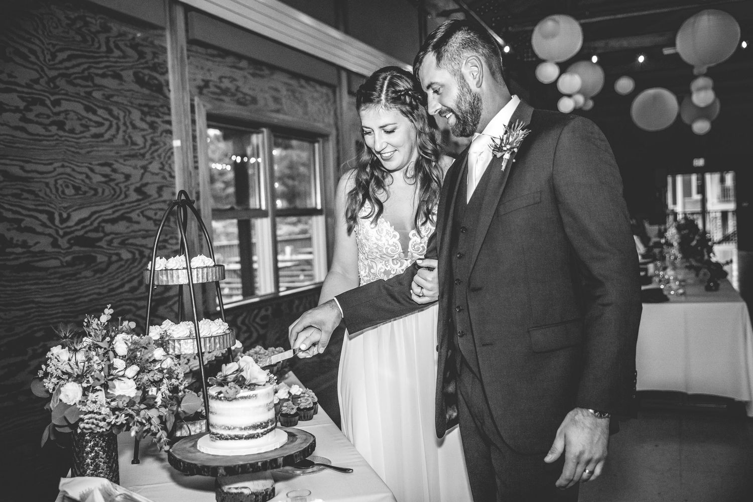 Wedding reception venue decorated with paper lanterns and rustic details.