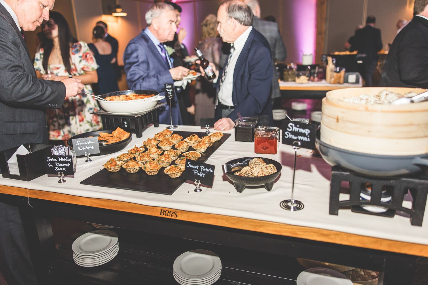 Wedding reception buffet table with appetizers and food displays.