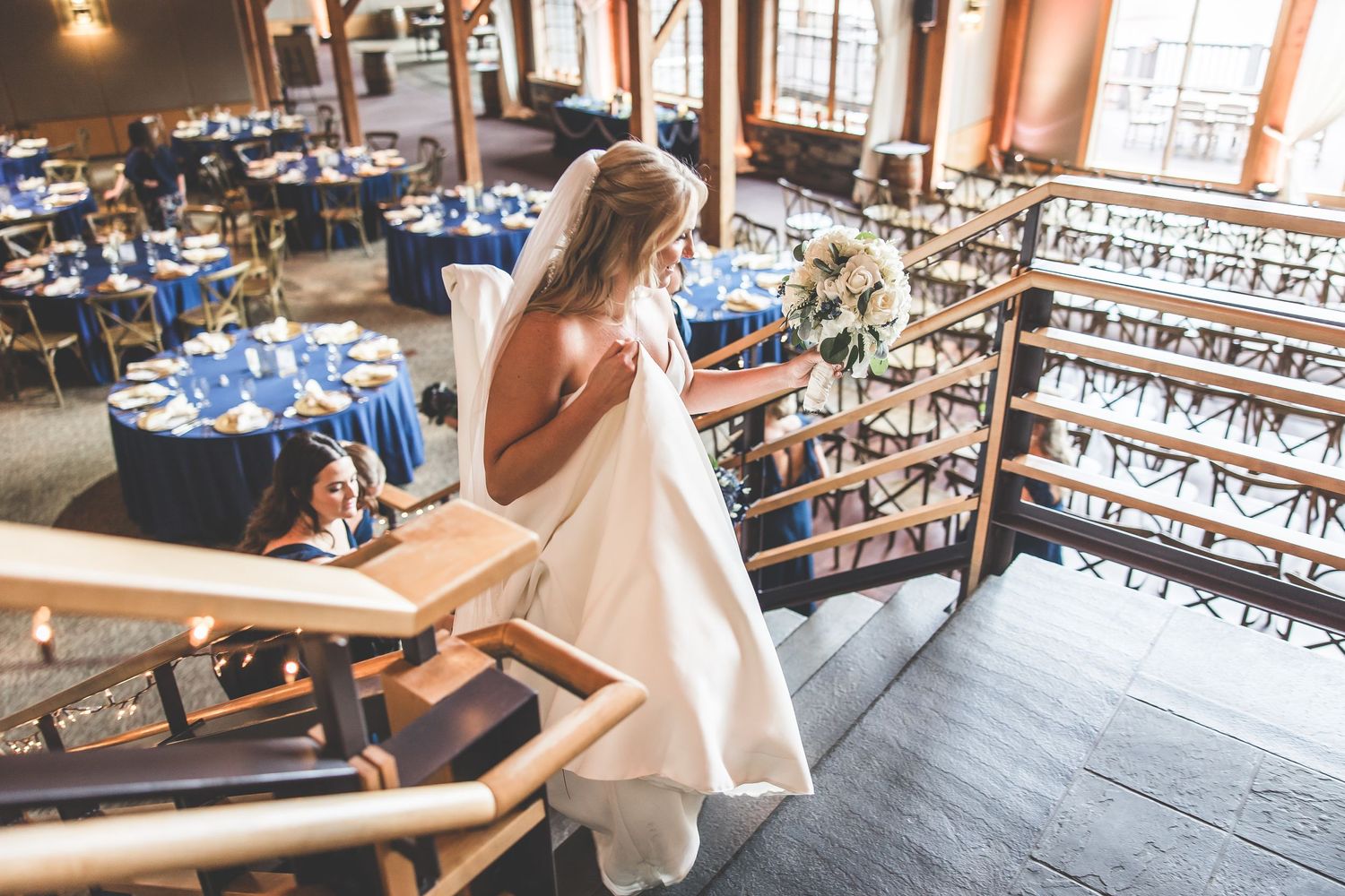 Interior of rustic wooden venue with natural lighting and wooden beams.