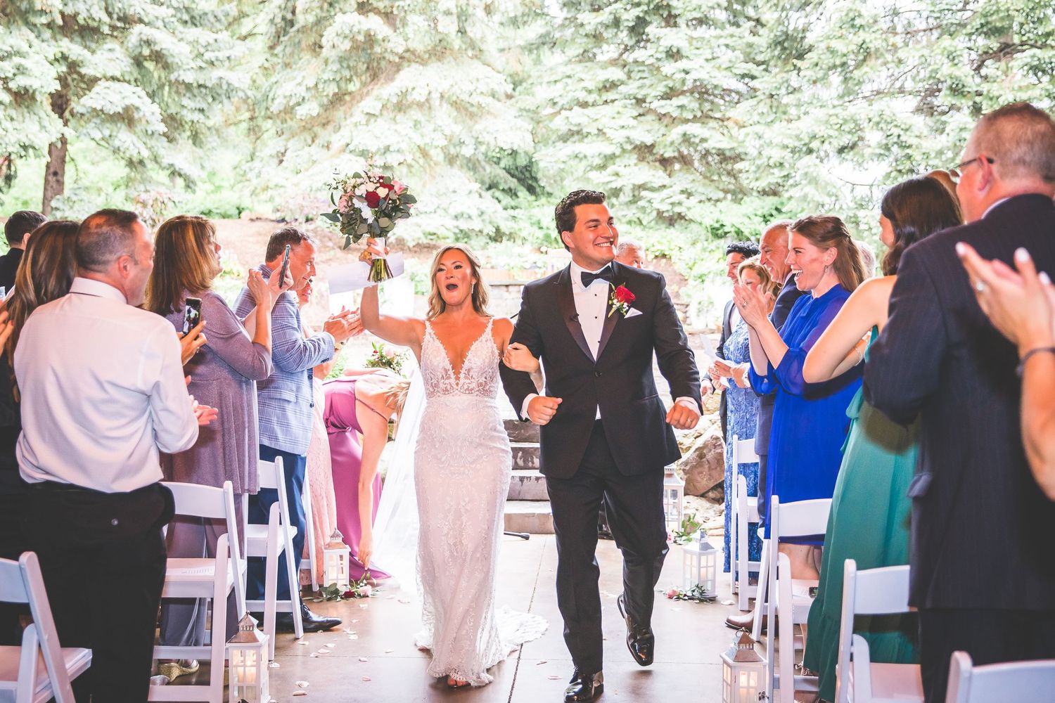 Wedding reception guests mingling and celebrating in an outdoor garden setting.