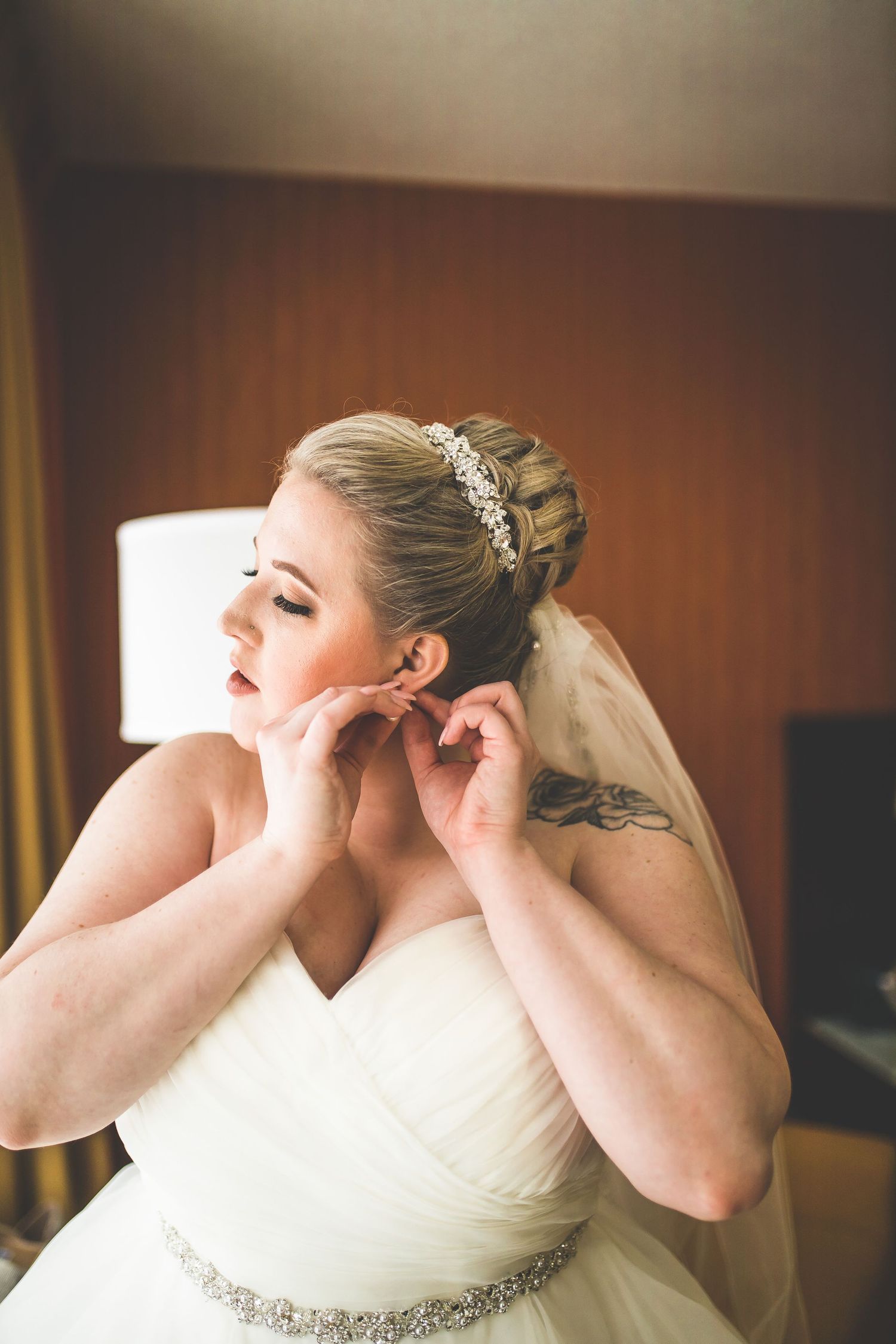 Wedding dress details showing beaded embellishments and veil attachments.