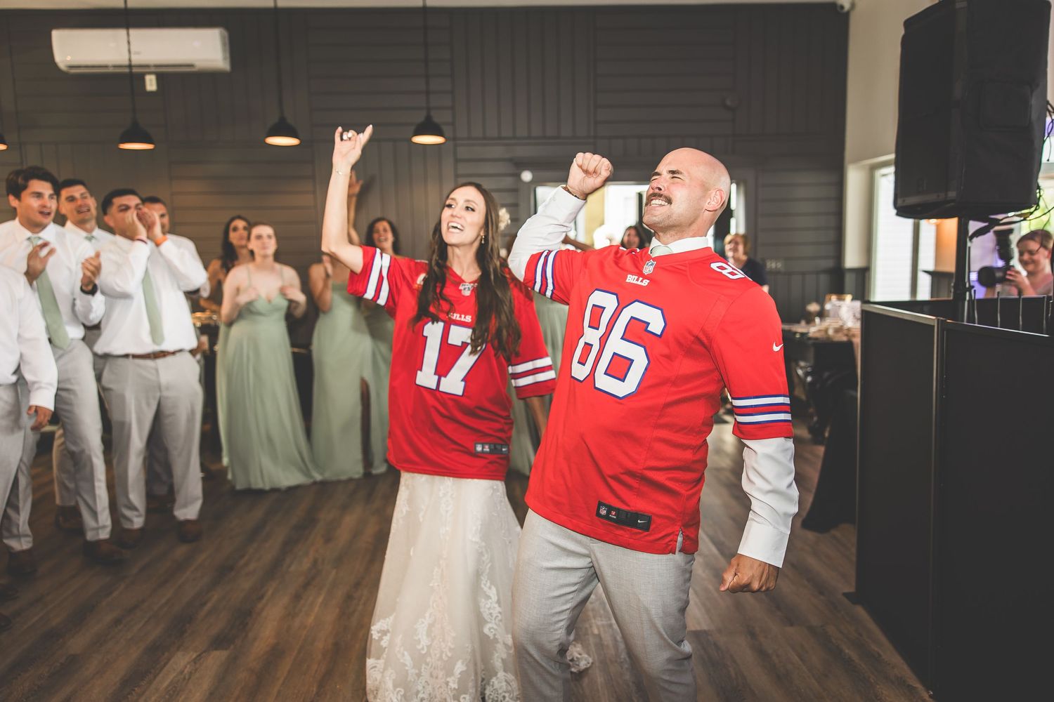 Wedding celebration with bridal party and sports fans mixing on the dance floor.