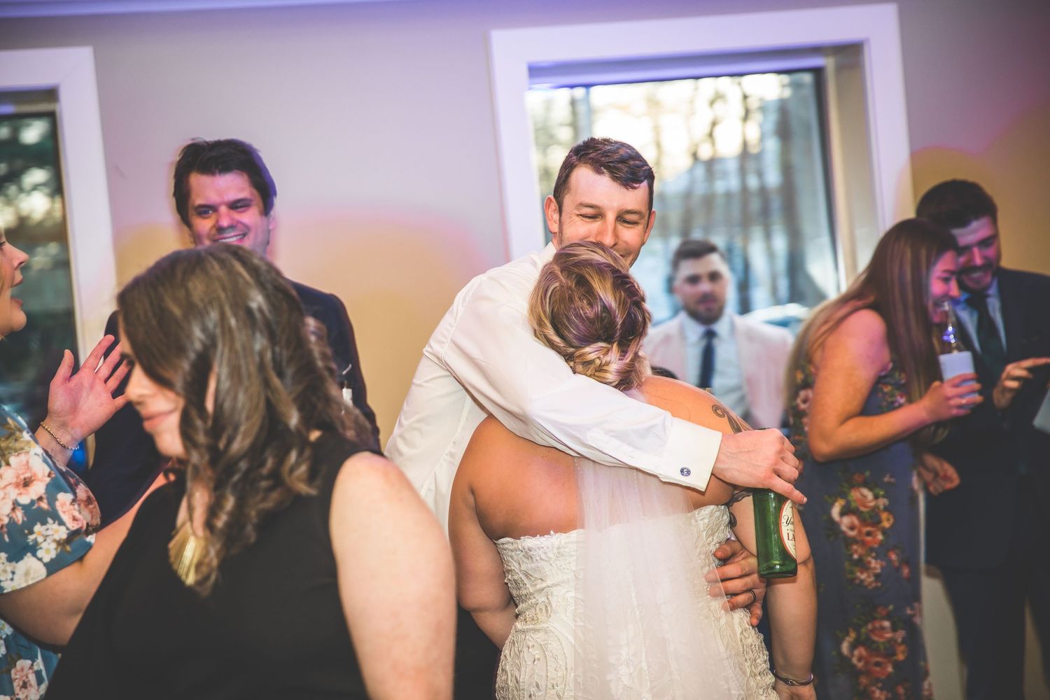Wedding guests dance and celebrate together during a lively reception party.