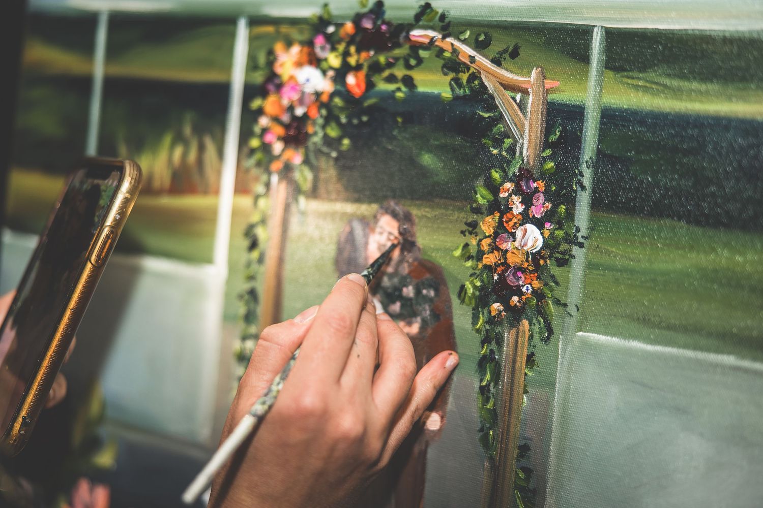 Intimate wedding ceremony moment under a decorated floral arch.