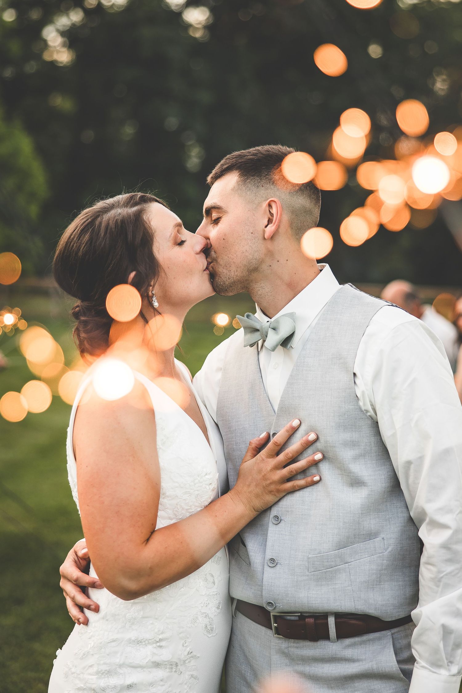 Romantic evening portraits with twinkle lights creating bokeh effect in background.