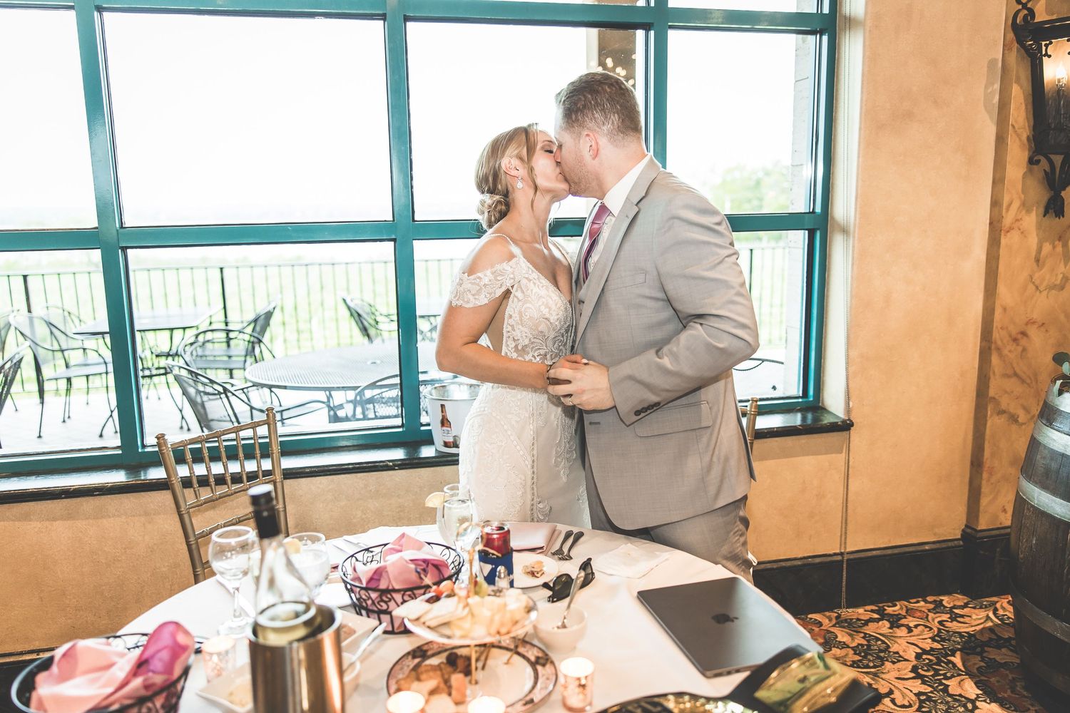 Elegant wedding venue with floor-to-ceiling windows and modern decor during a reception.
