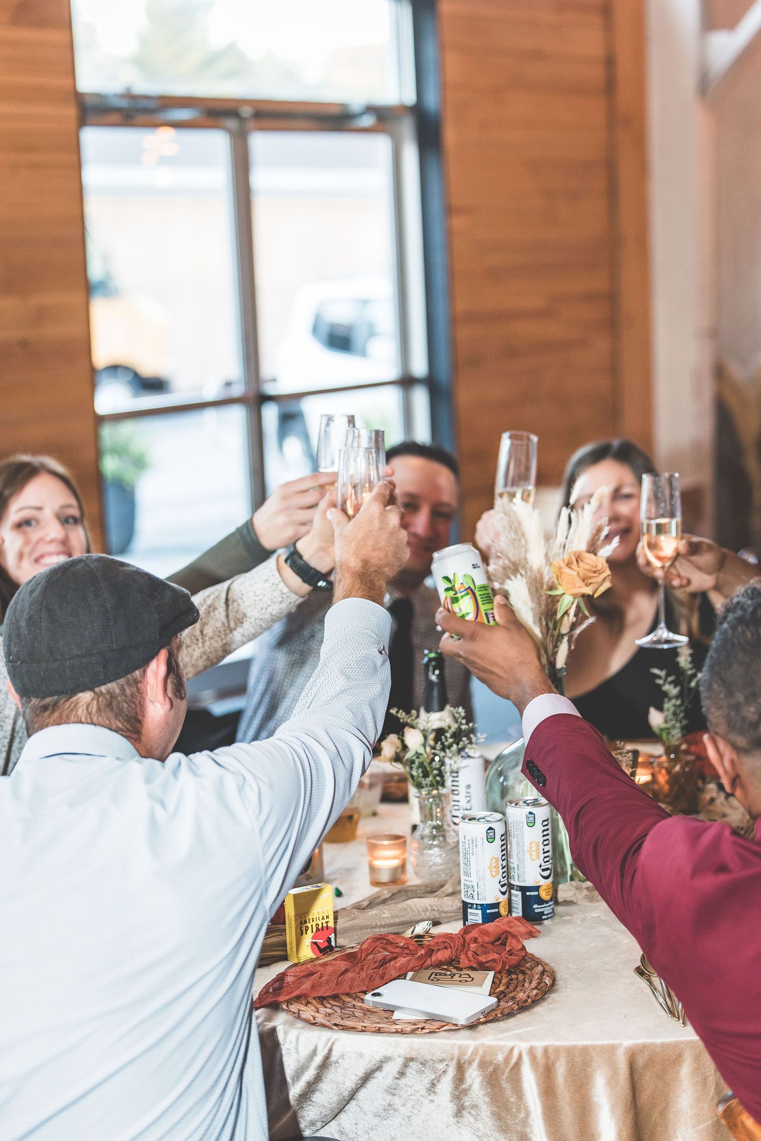 Wedding guests raise their glasses in celebration during reception toasts.