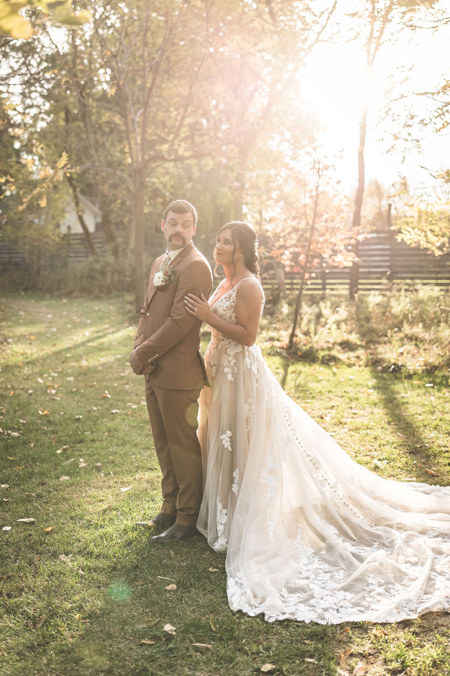 Sunlit wedding portraits capture intimate moments between newlyweds in a rustic outdoor setting.