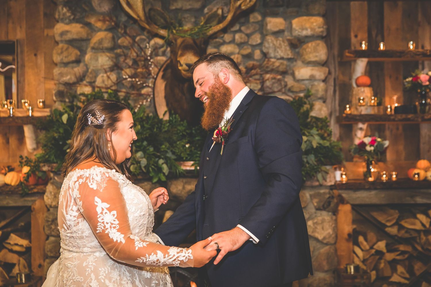 Couple dancing together in intimate rustic venue with stone walls and ambient lighting.