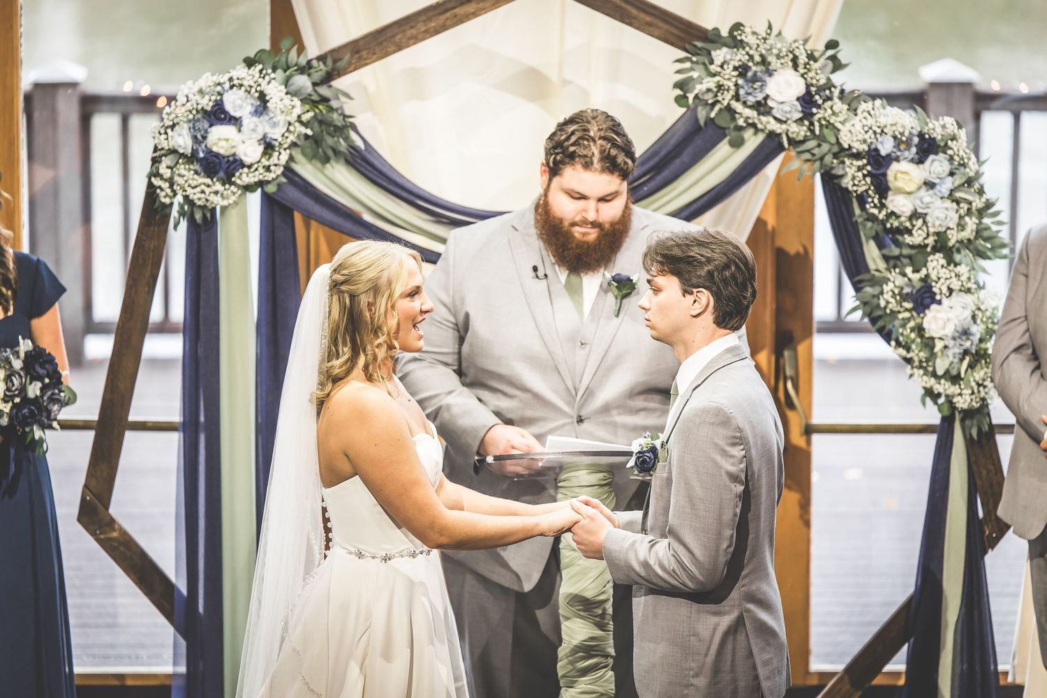 A wedding ceremony sequence shows a couple exchanging rings in front of floral decorations and draped fabric.